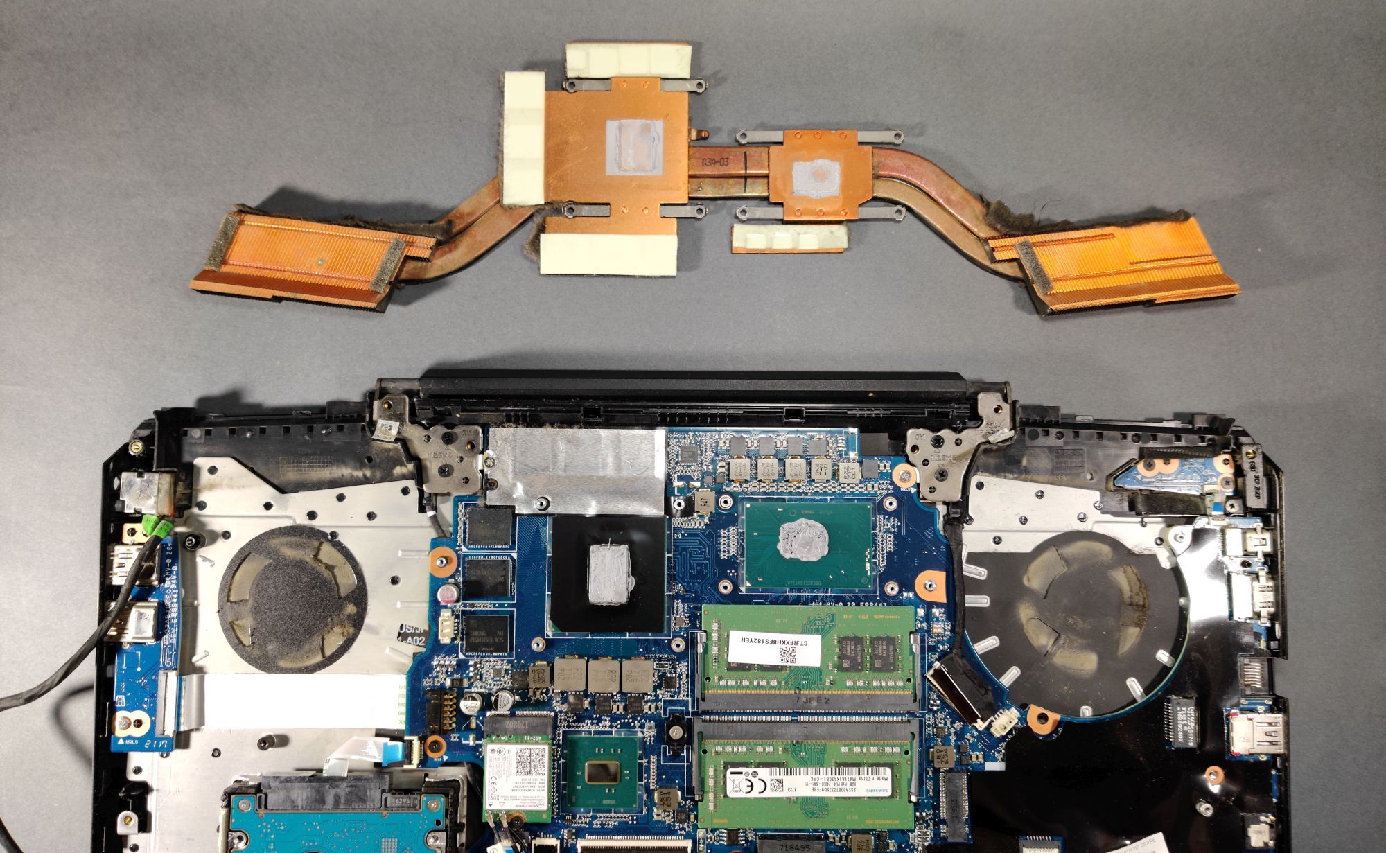 Laptop disassembled for thermal paste replacement.