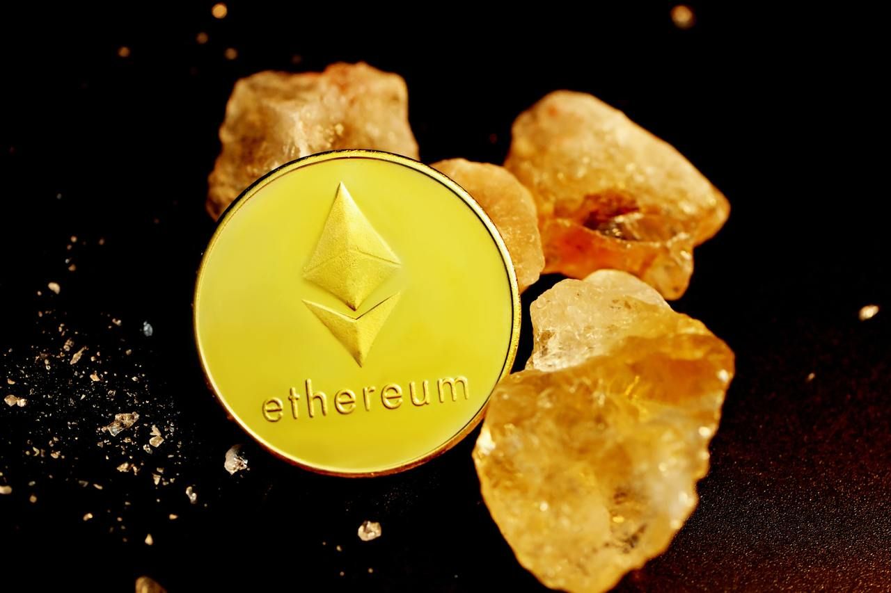 One Ethereum coin surrounded by three crystals