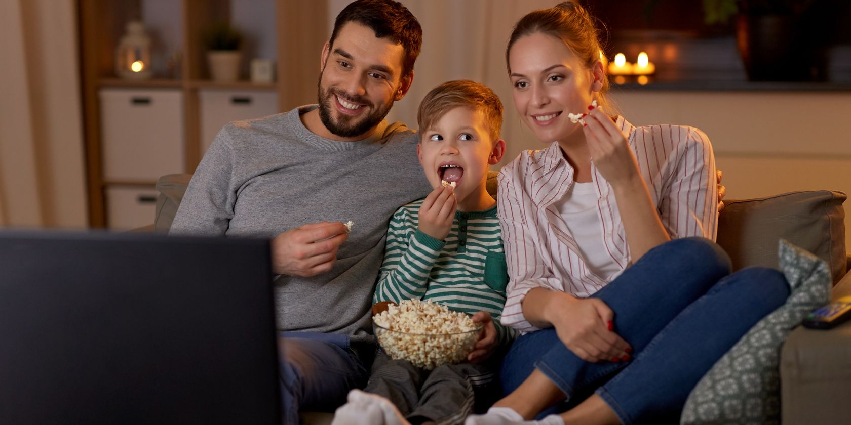 family watching tv eating popcorn