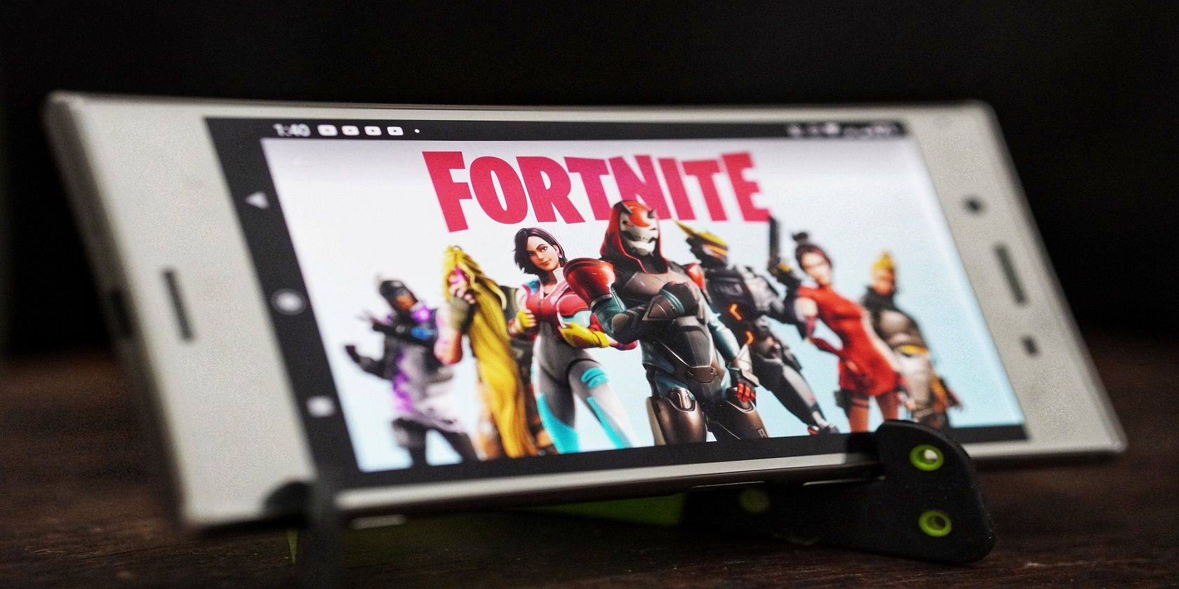 Fortnite logo and characters on mobile phone screen