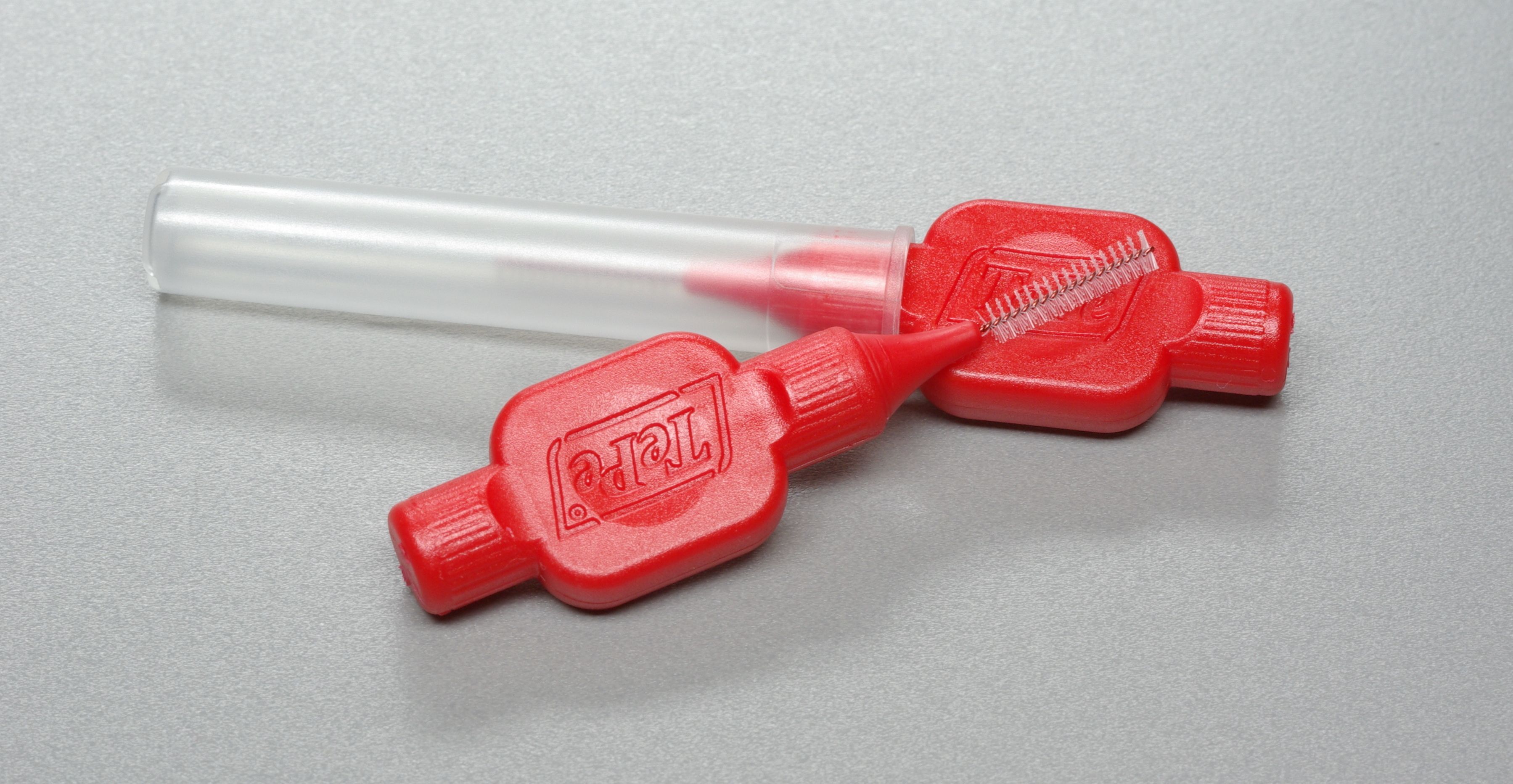 pair of red interdental brushes