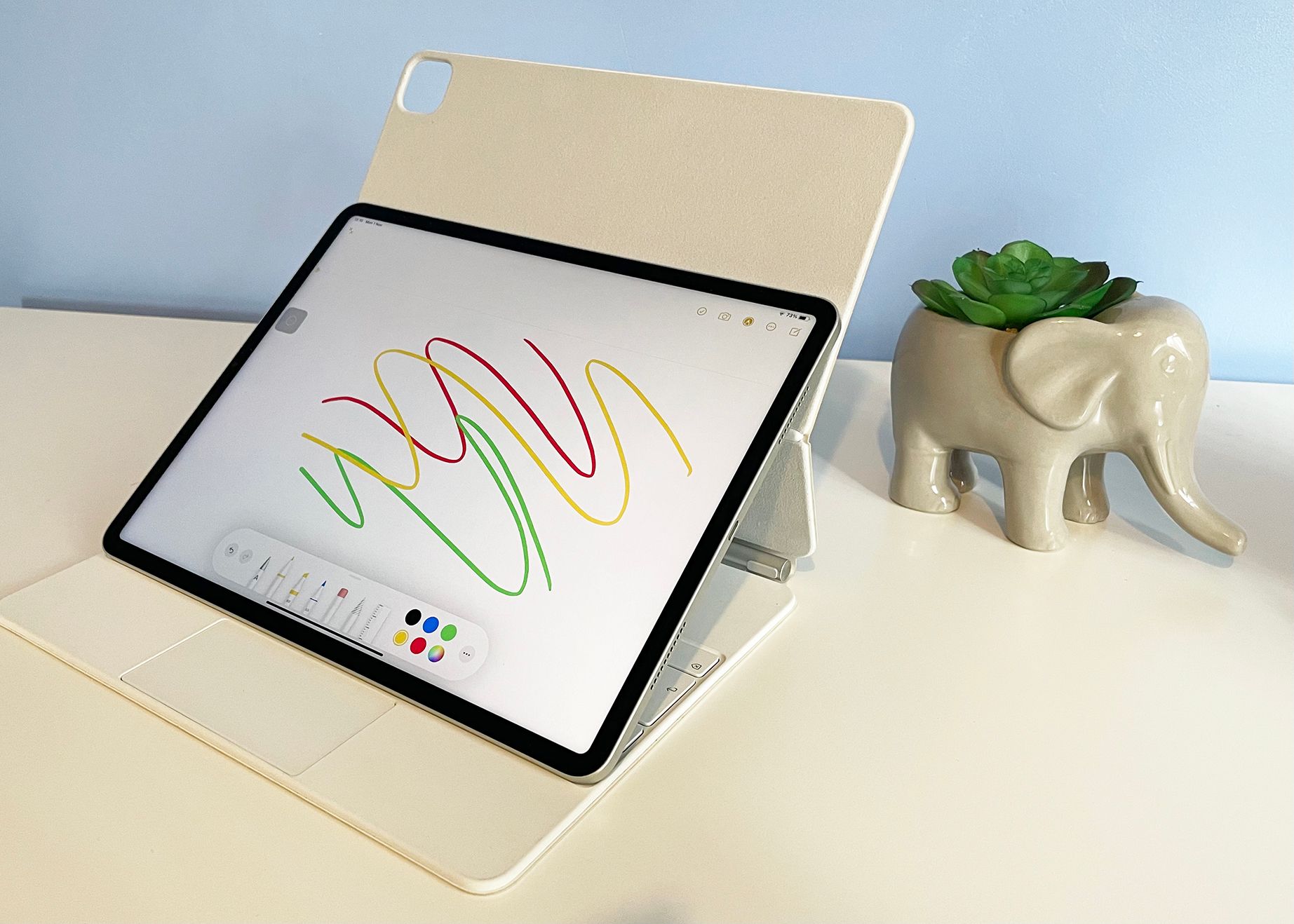 white iPad Pro Magic Keyboard in Easel Mode on a white desk