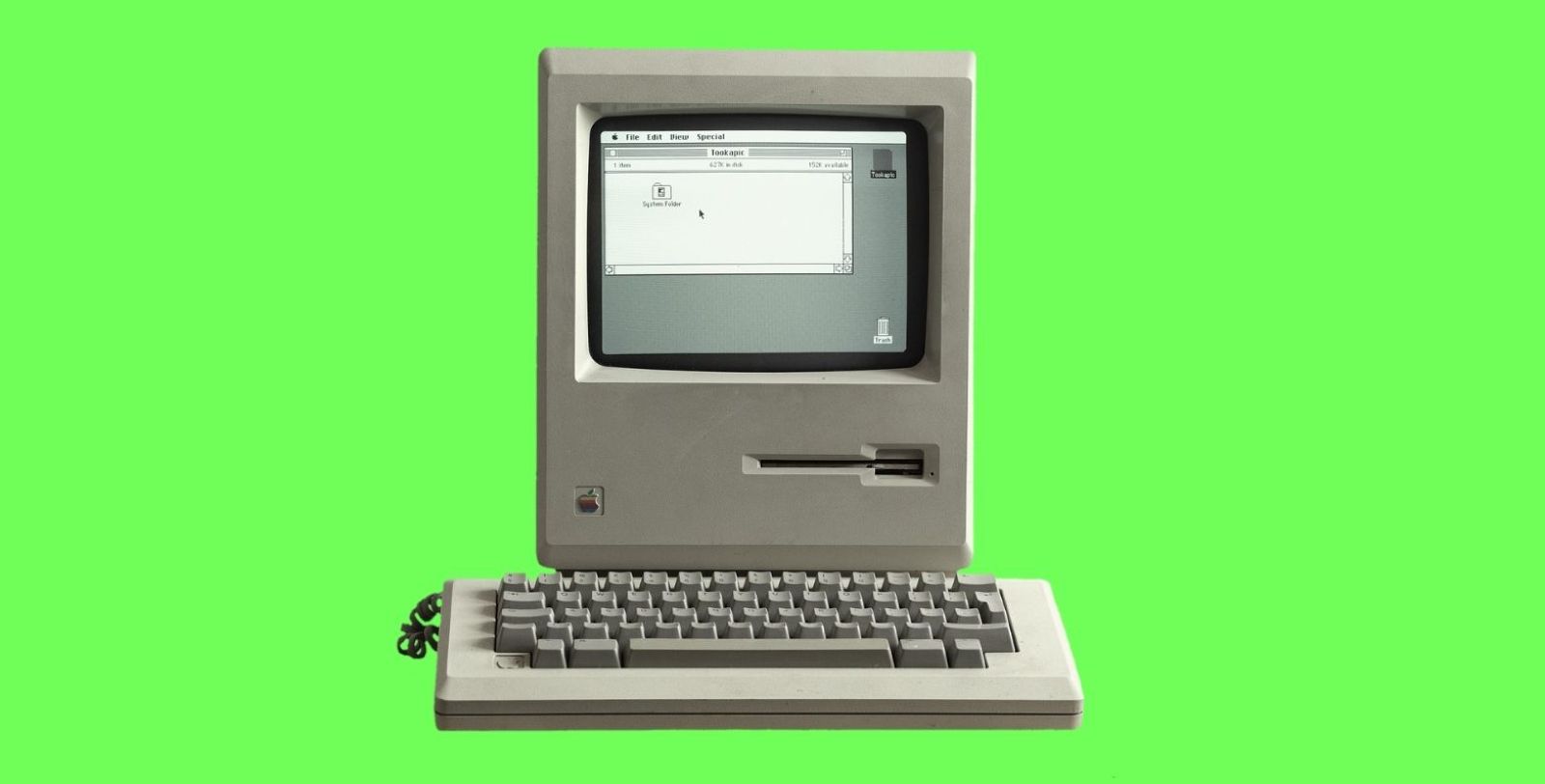 Vintage personal computer on green background