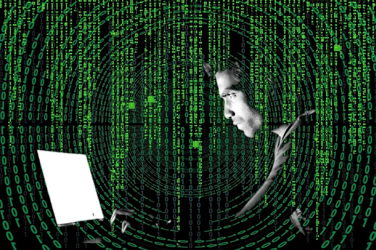 face of man coding a computer creating crytpo