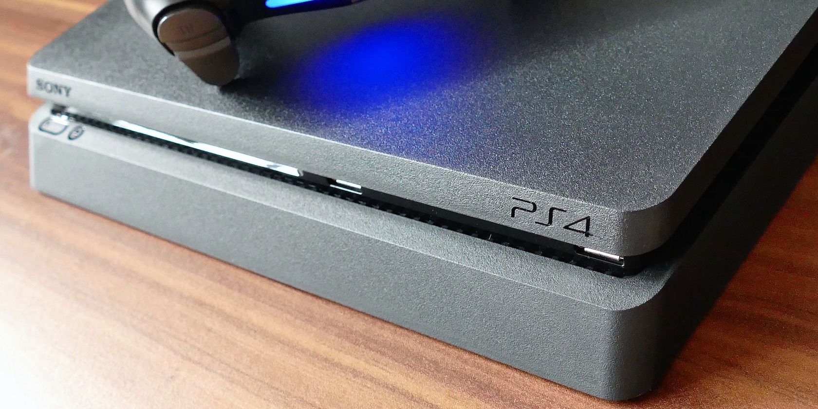 PS4 slim on wooden table