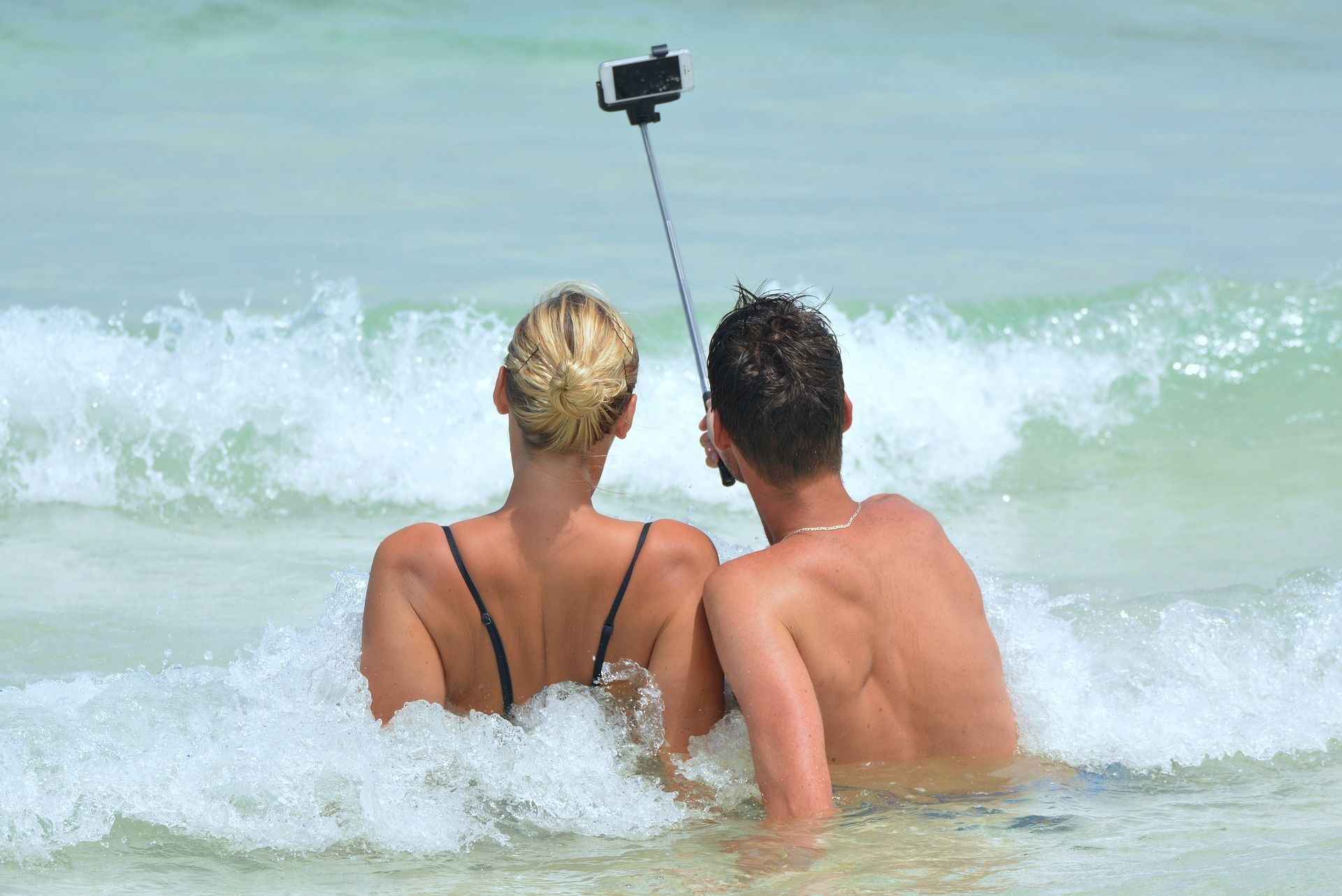two people in water taking selfie