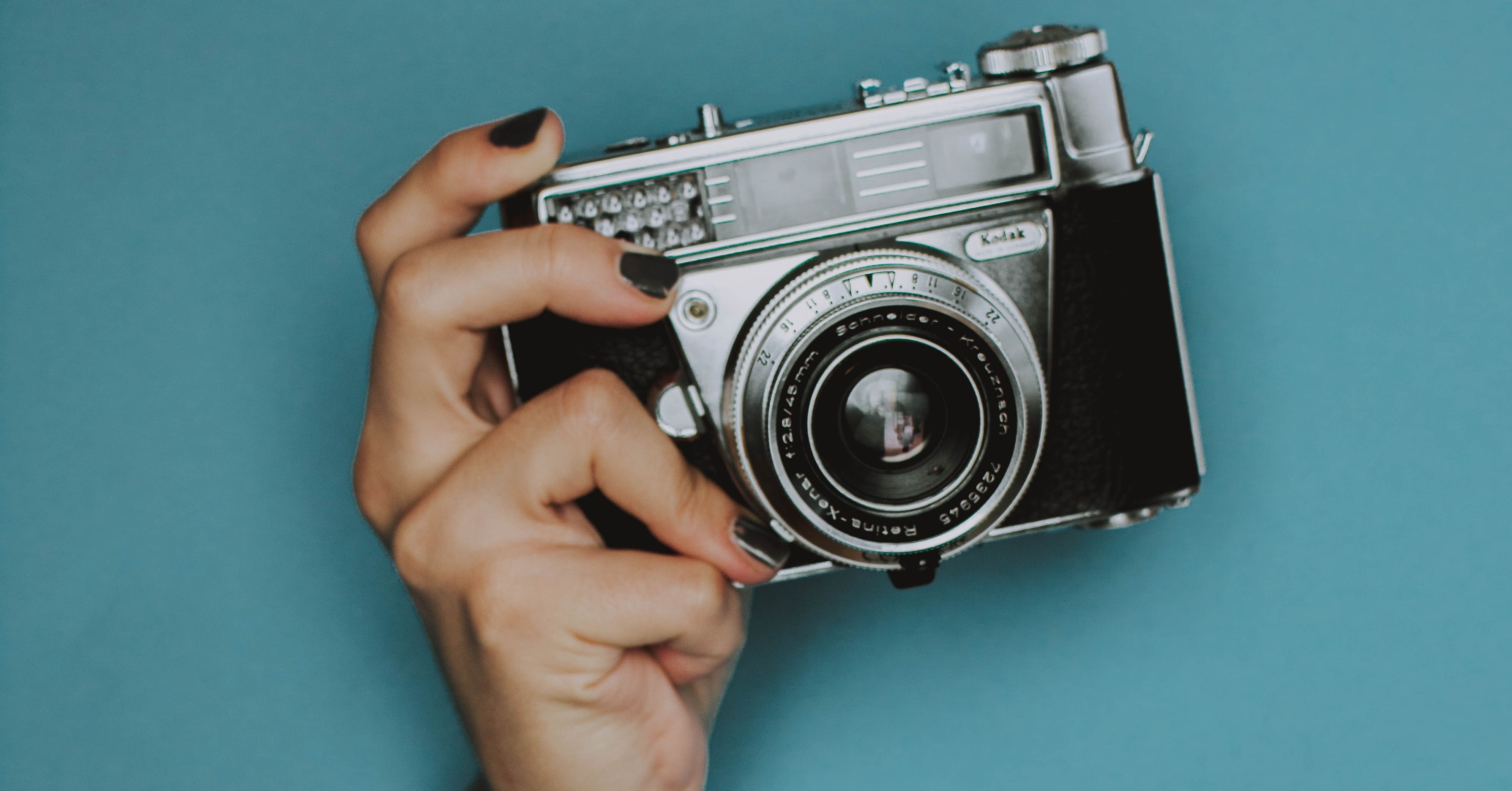 woman holding vintage camera