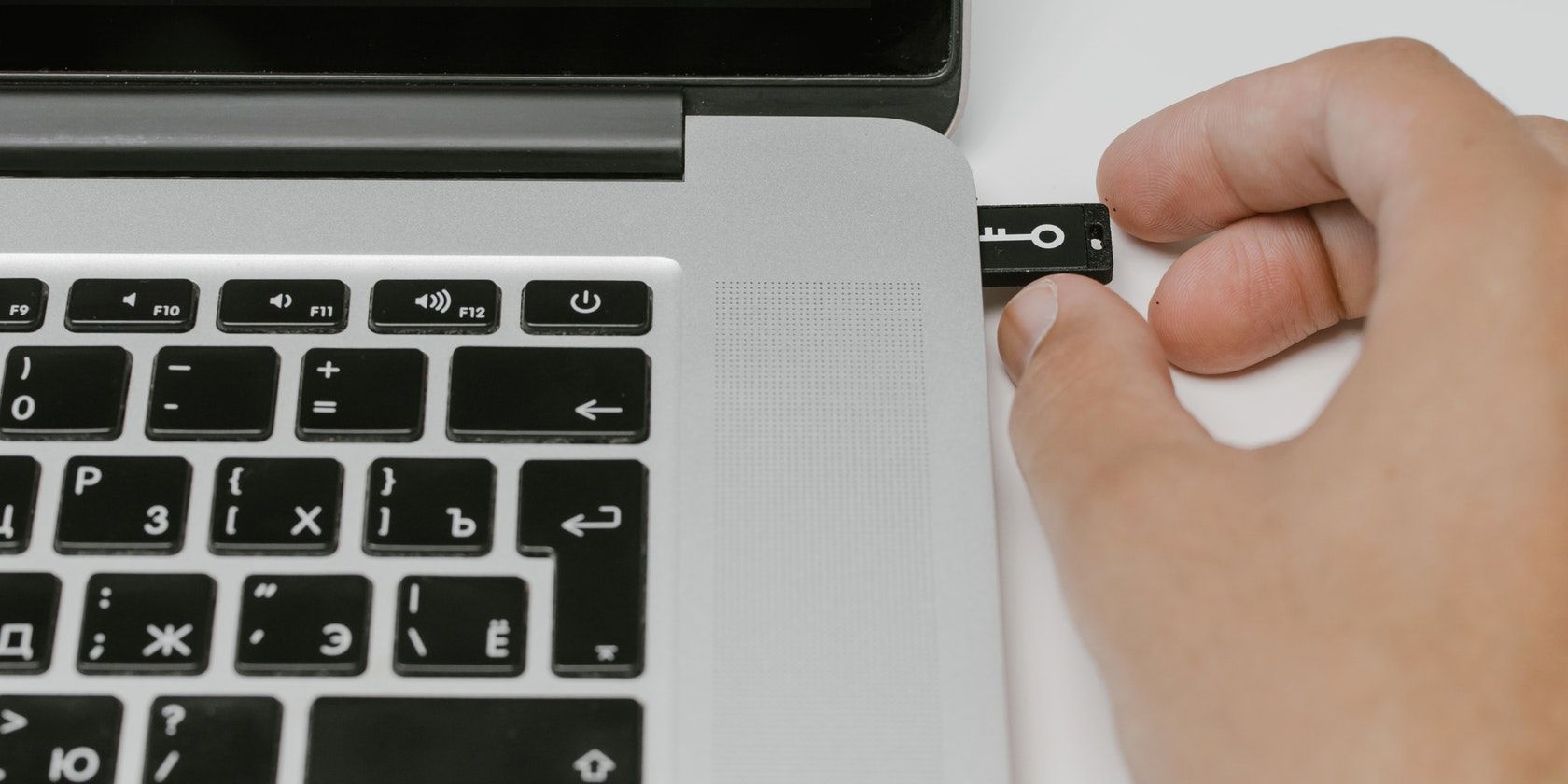 Close Up Image of a Man Inserting USB Drive To Laptop