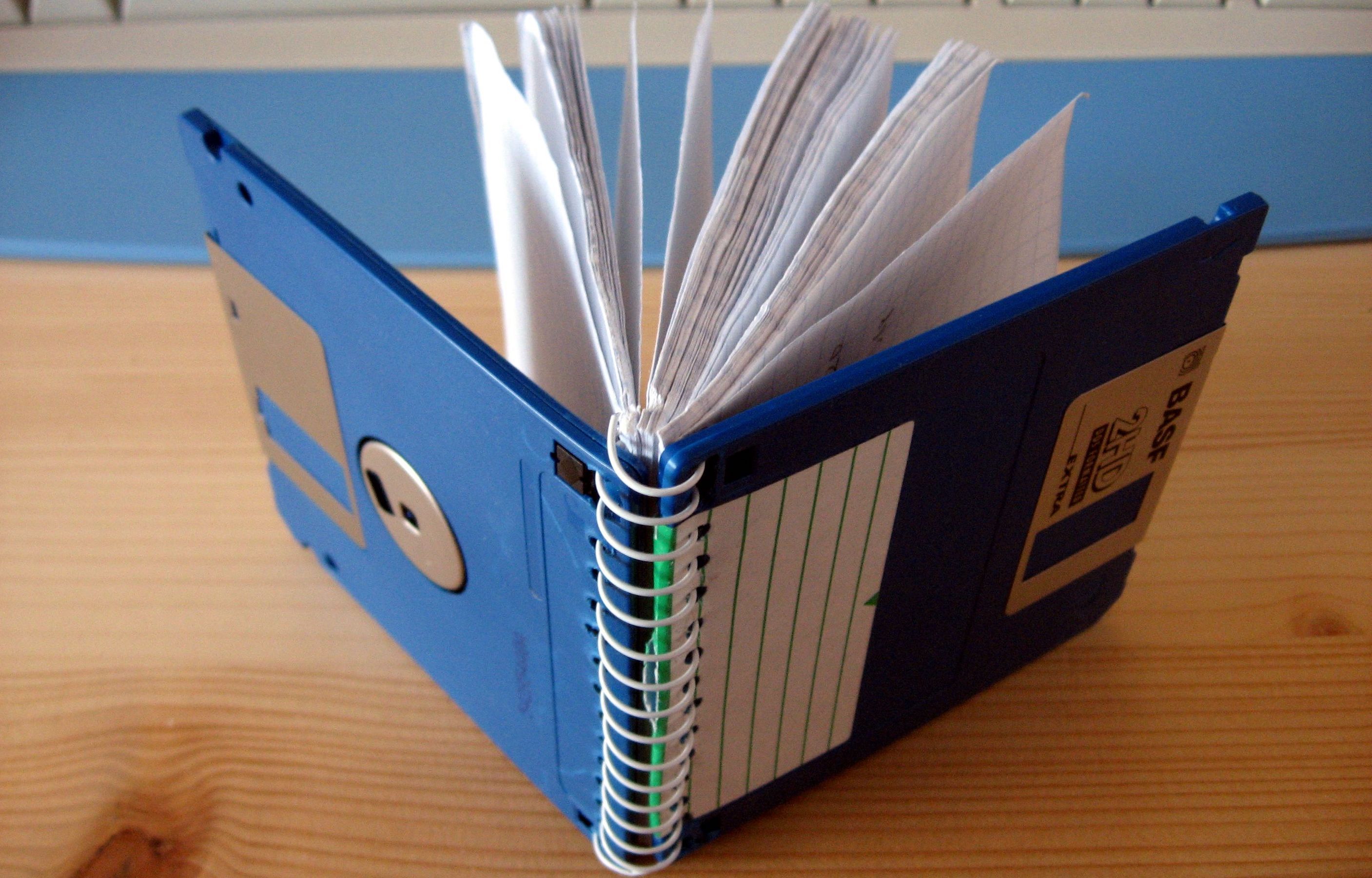 A close up shot of a notepad made with two floppy disks