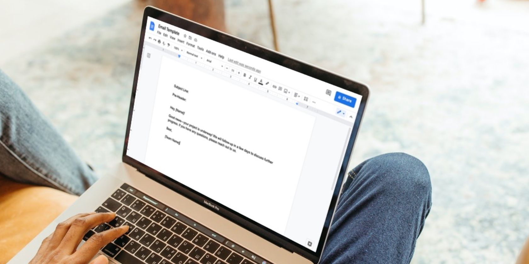 Image shows a man using a Google Docs template on a MacBook
