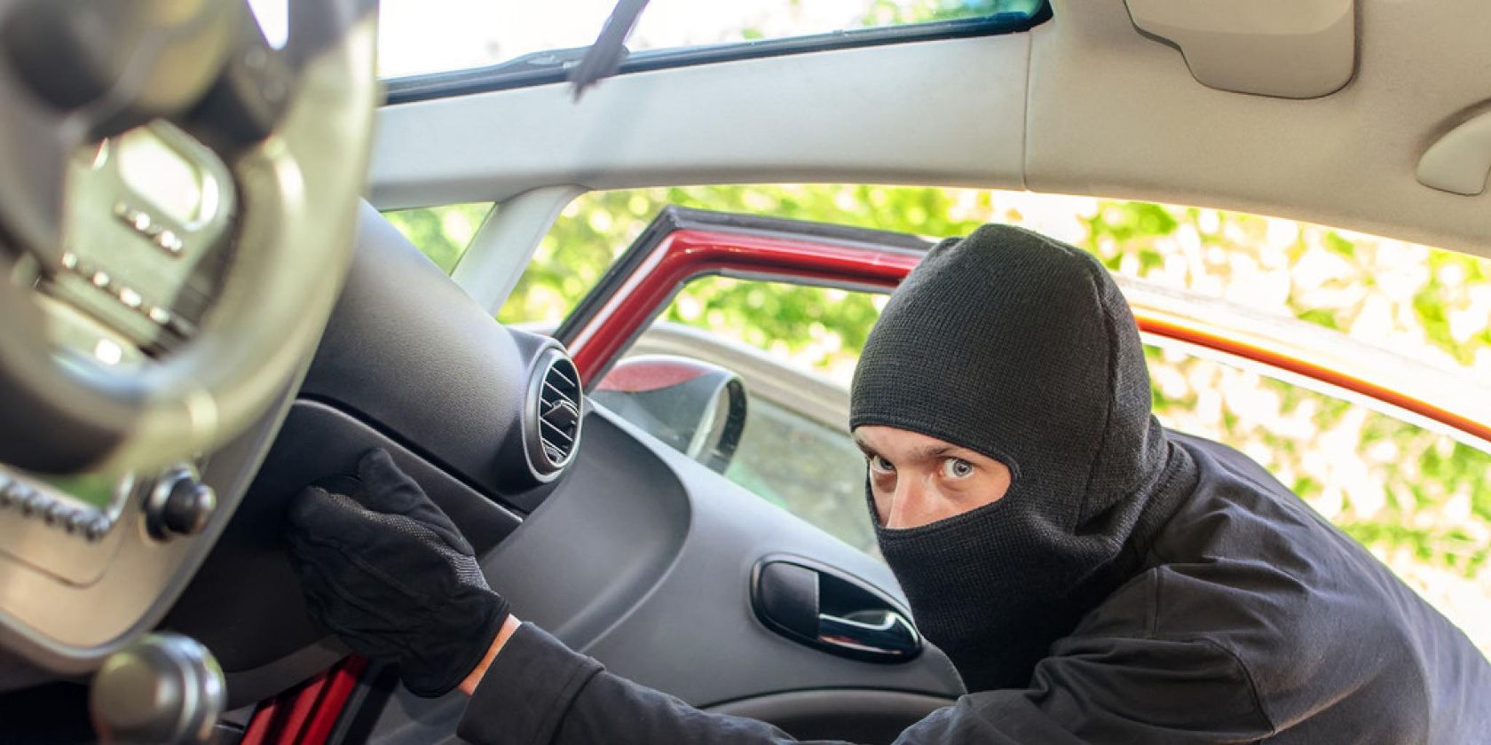 A car thief is accessing a car