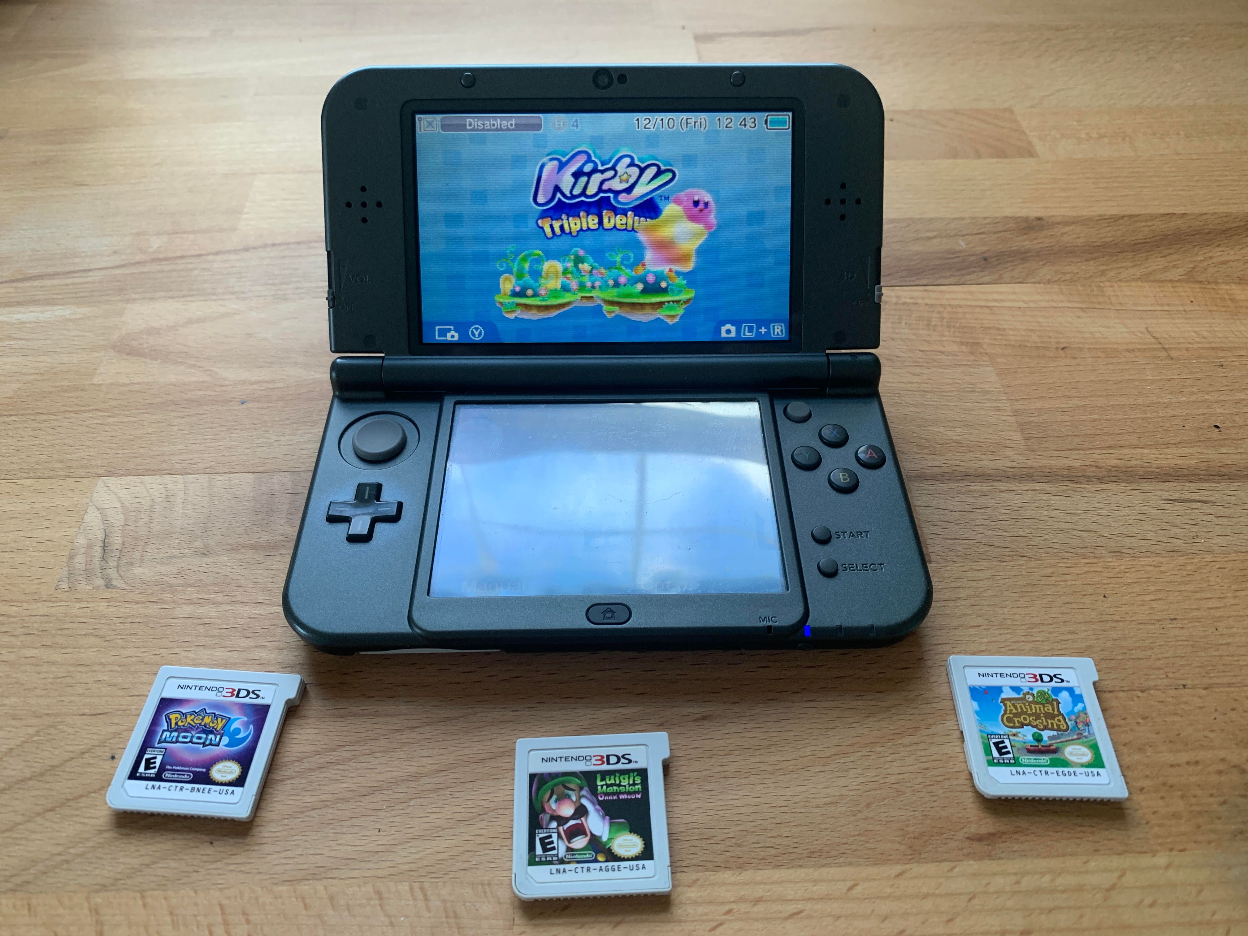 Grey New Nintendo 3DS XL Surrounded by Games