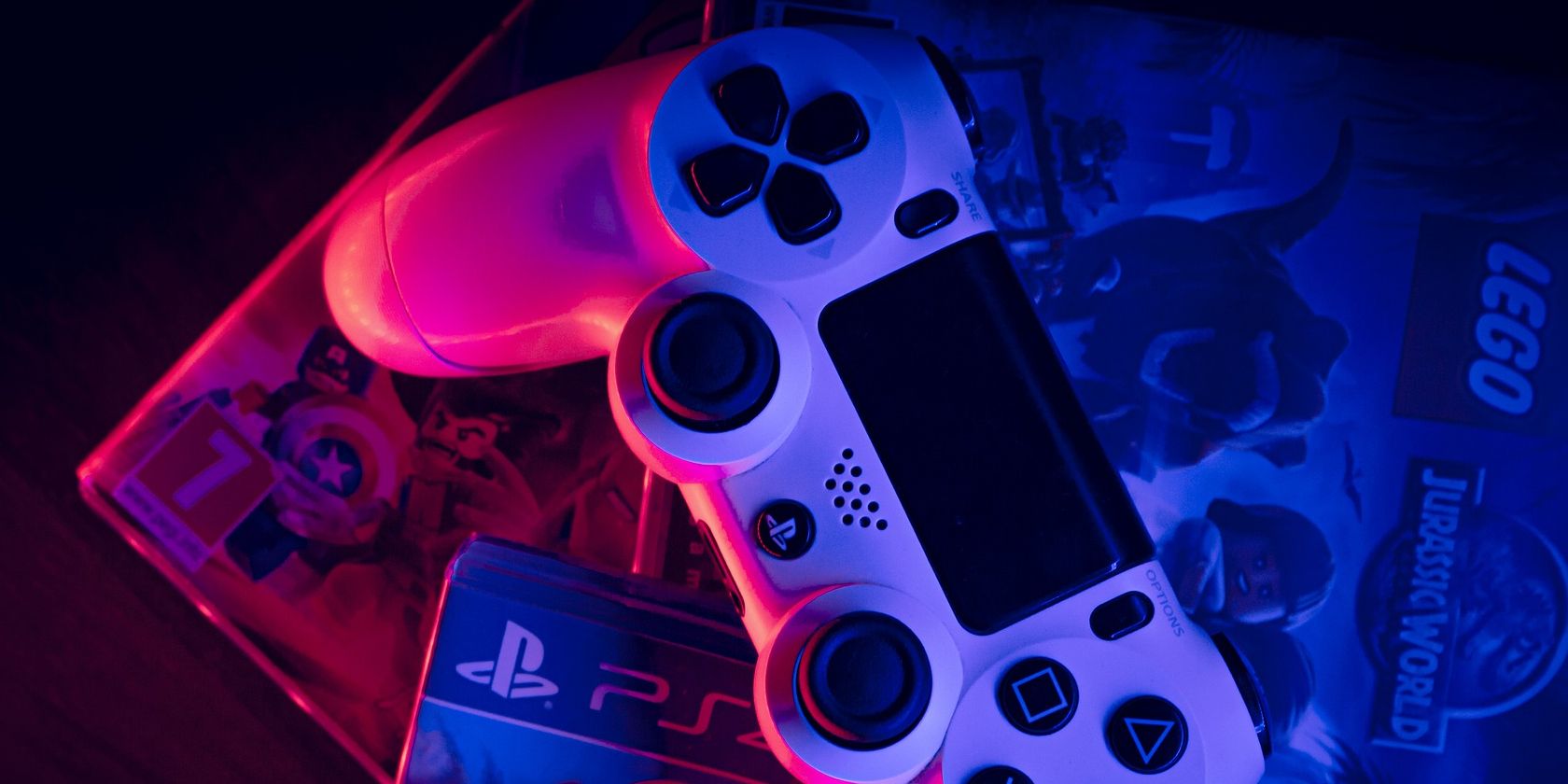White PlayStation 4 controller on top of PS4 games