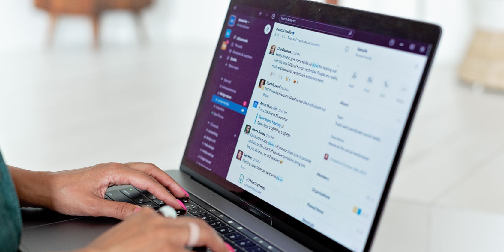 Image shows a woman using a laptop with Slack displayed on the screen
