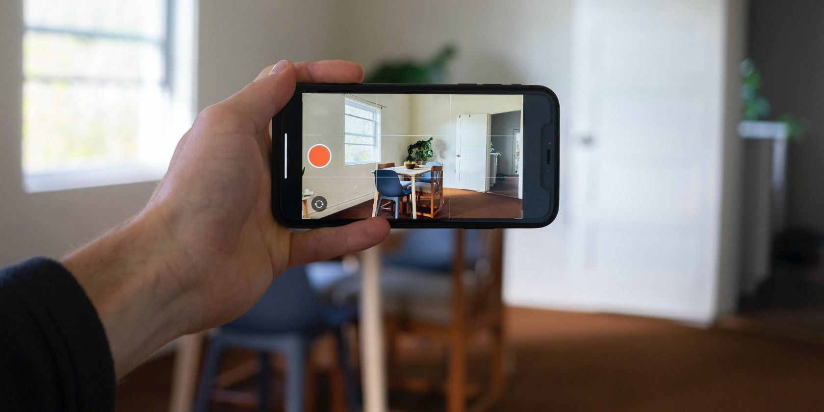 Person creating a virtual tour using a smartphone