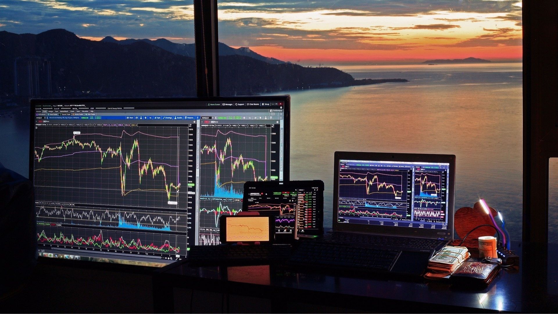 a bunch of different monitors with photos of the stock trading market