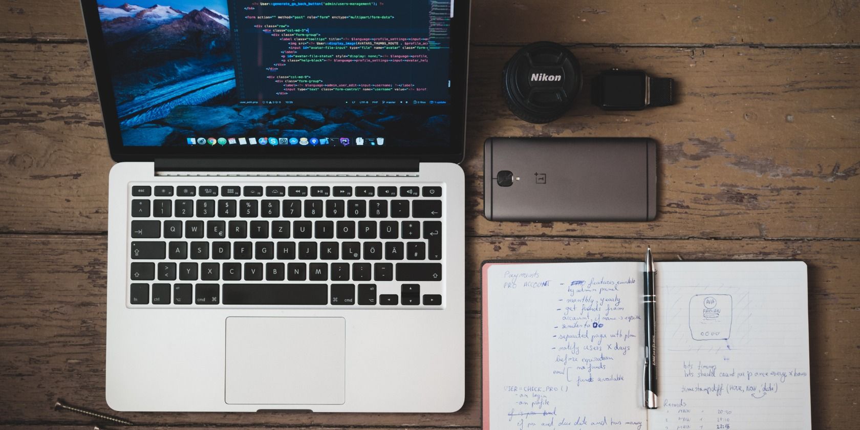 Macbook with a diary next to it