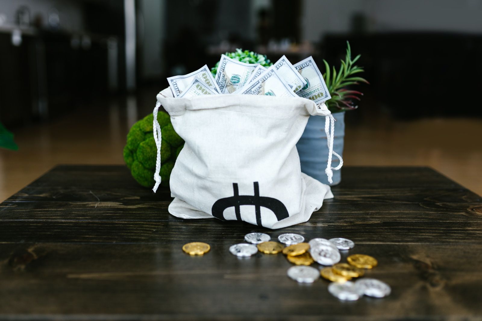 bag of money and crypto coins spread over table