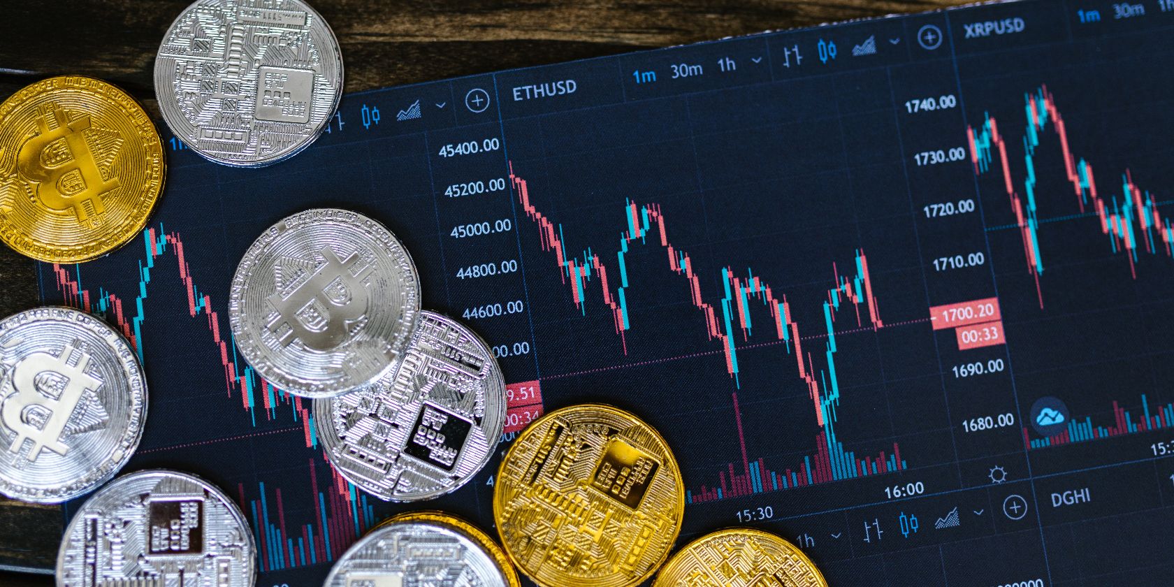 bitcoins next to paper chart