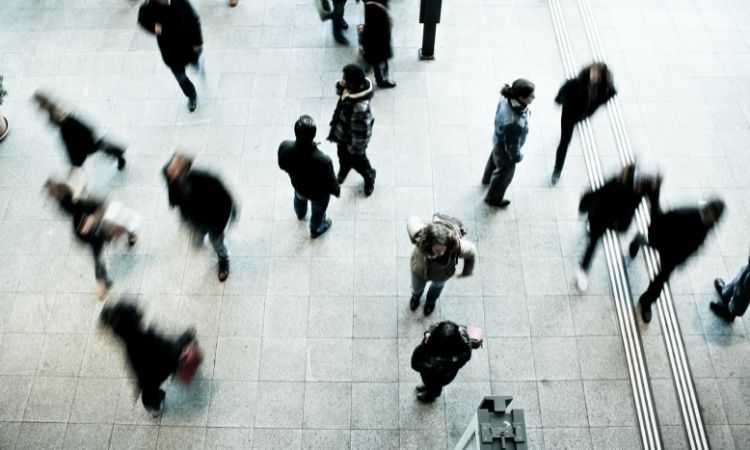 blurred image of people walking in a crowded area