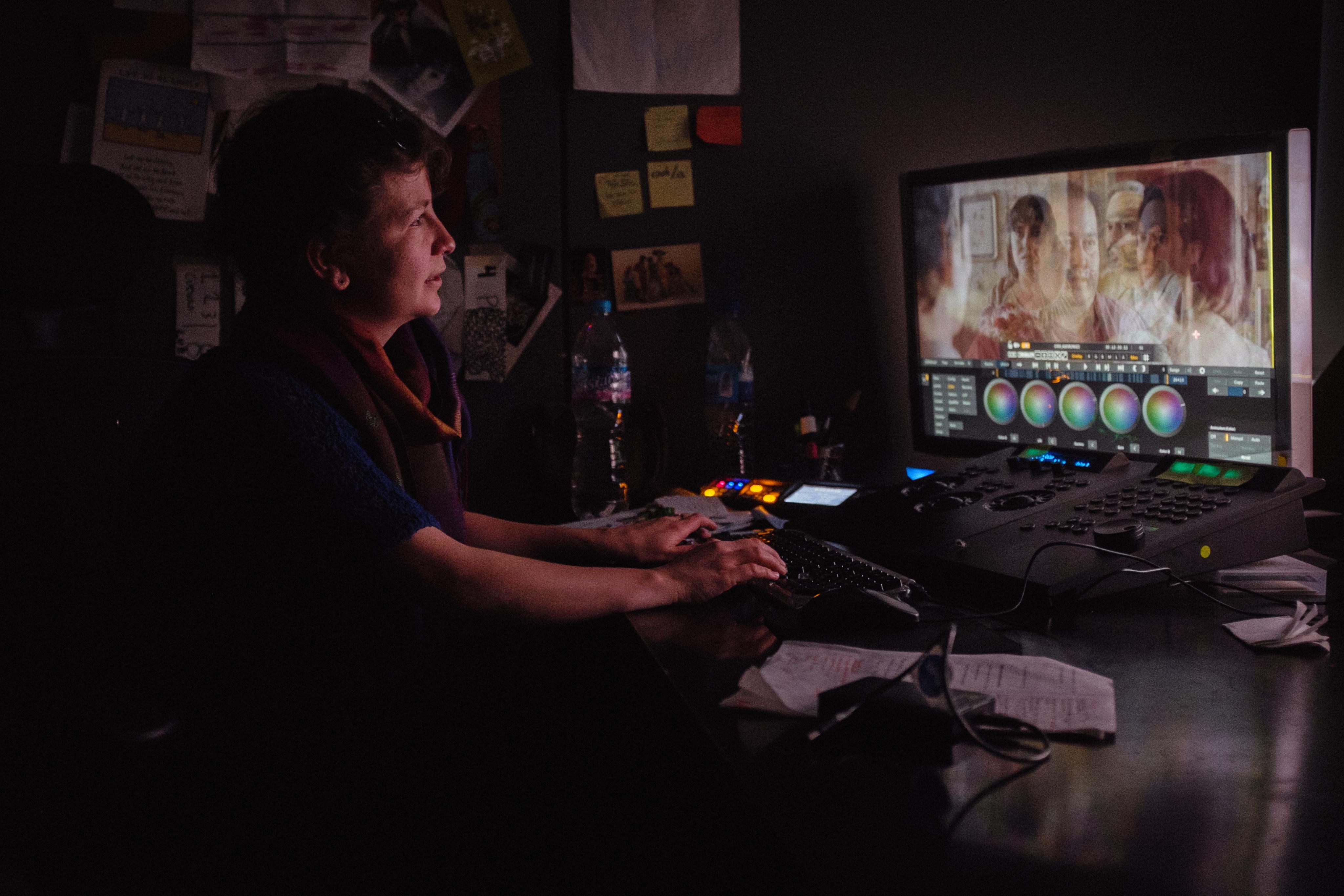 A woman color grading some footage.