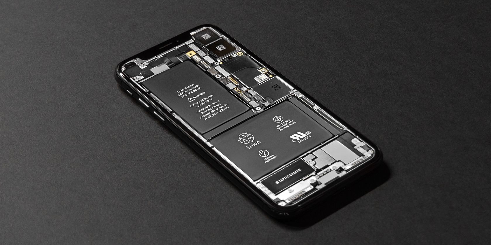 disassembled iPhone showing its batteries