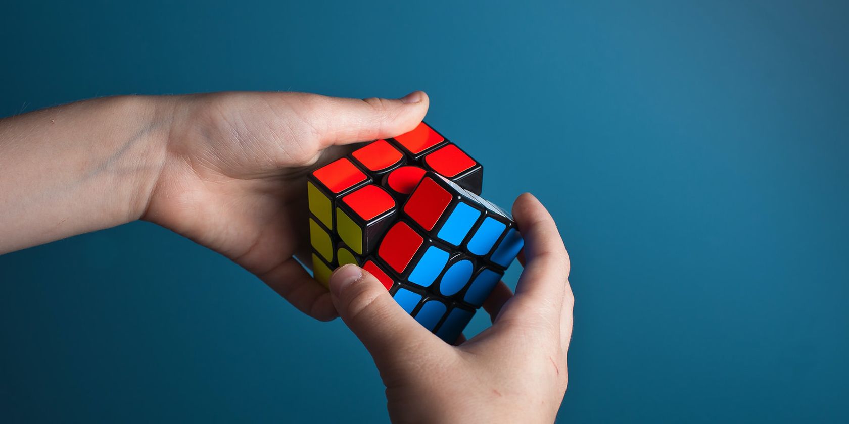 hands solving Rubik's Cube