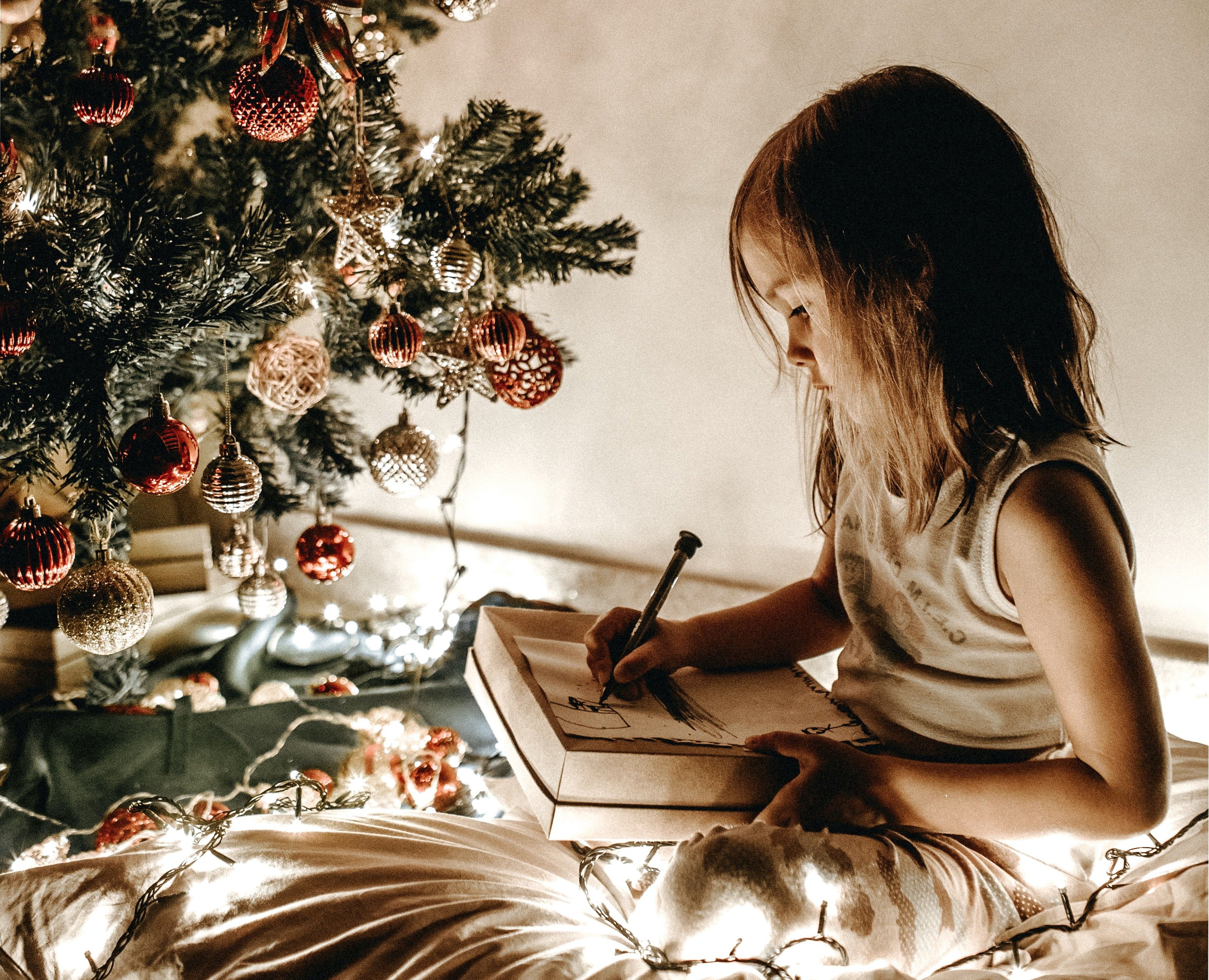 A girl writing a list for Santa.