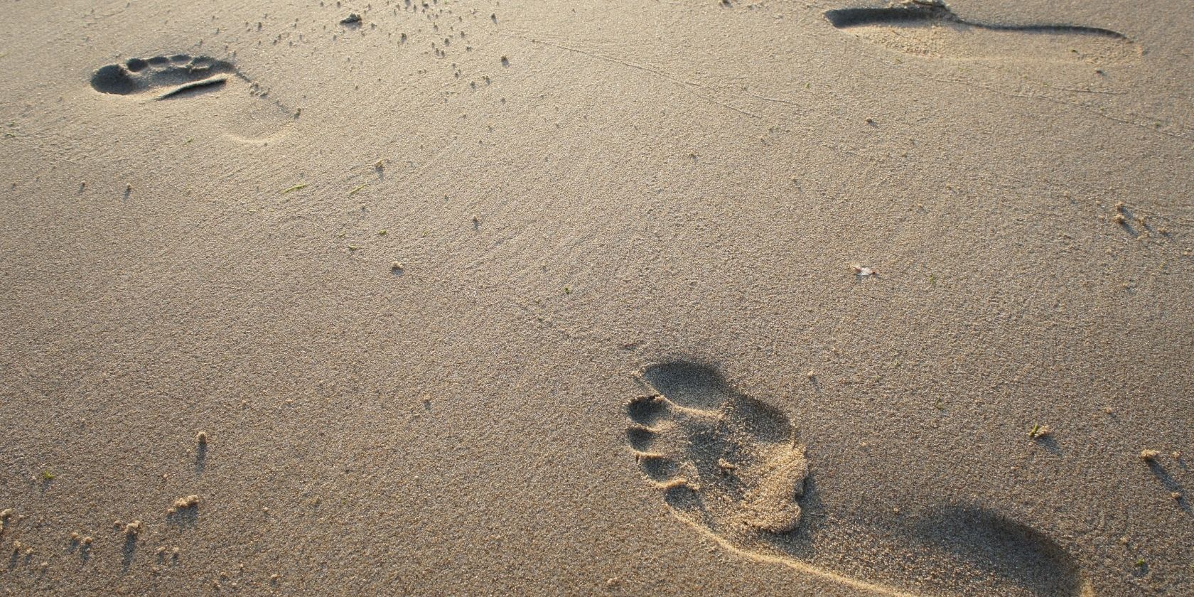 three footprints in the sand