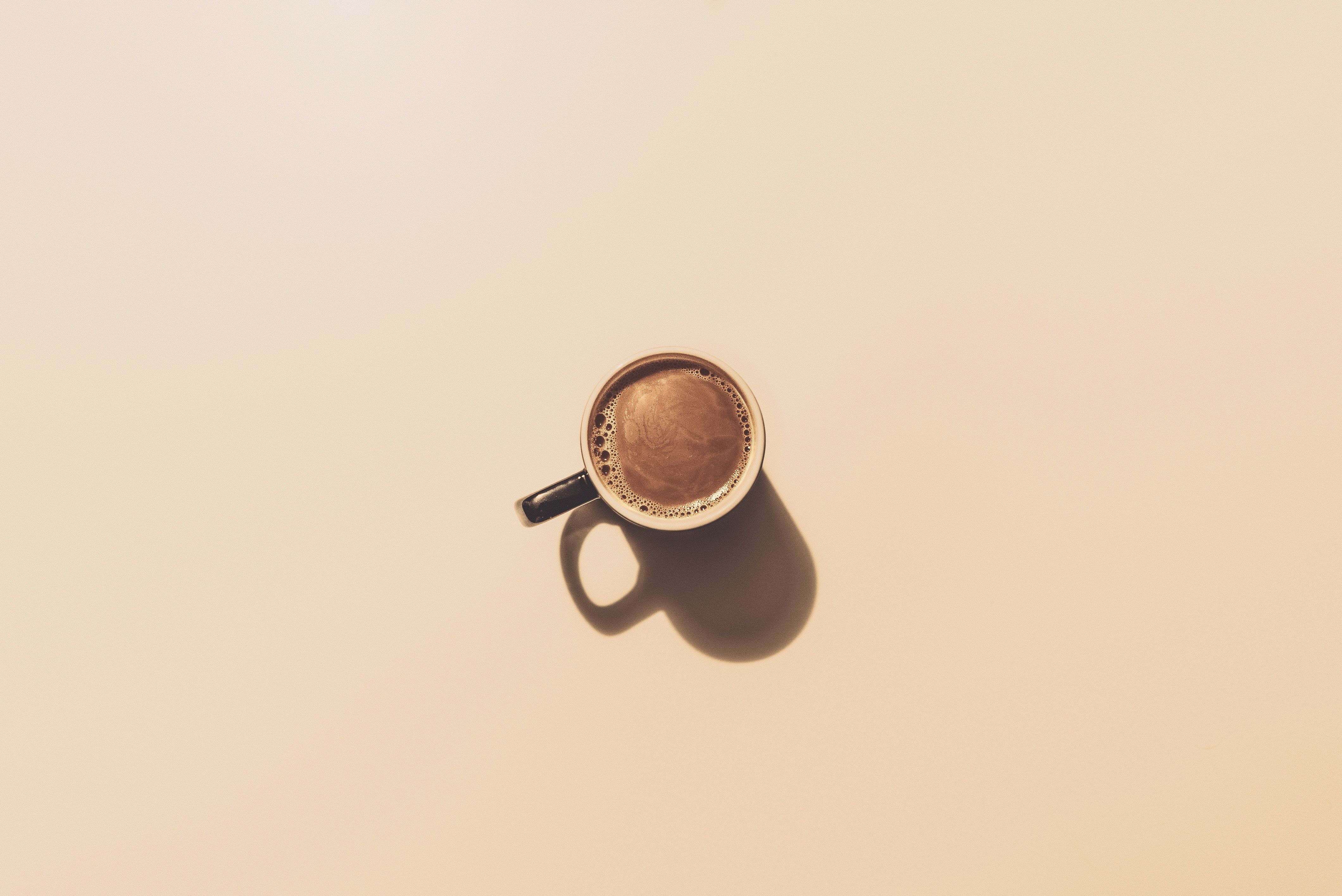 A cup of coffee over beige.