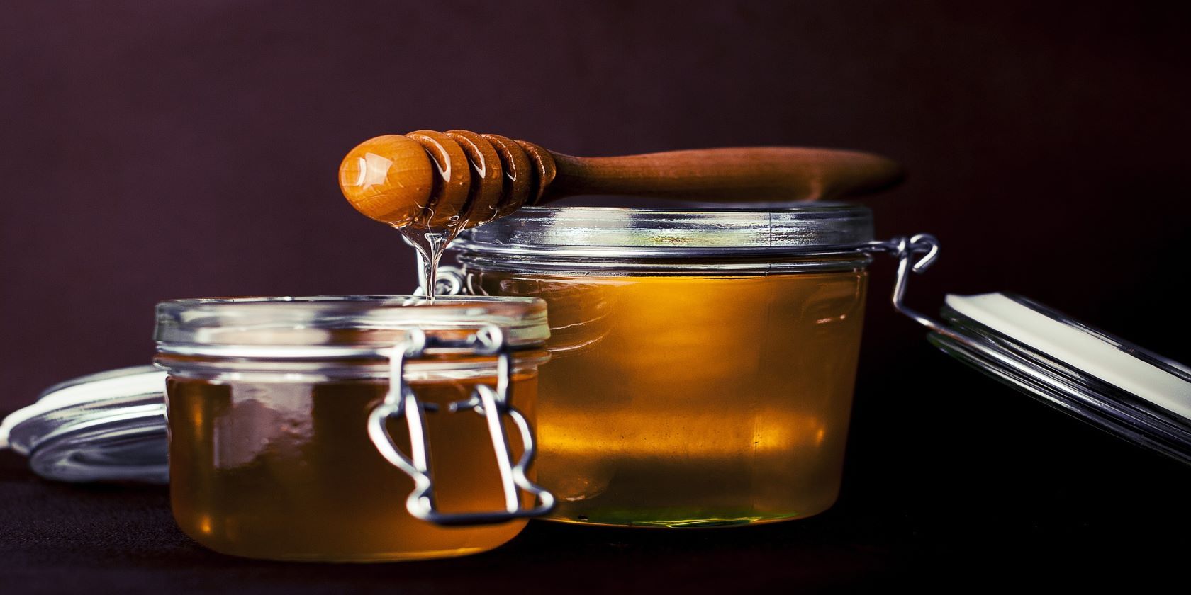 Two jars filled with honey. 
