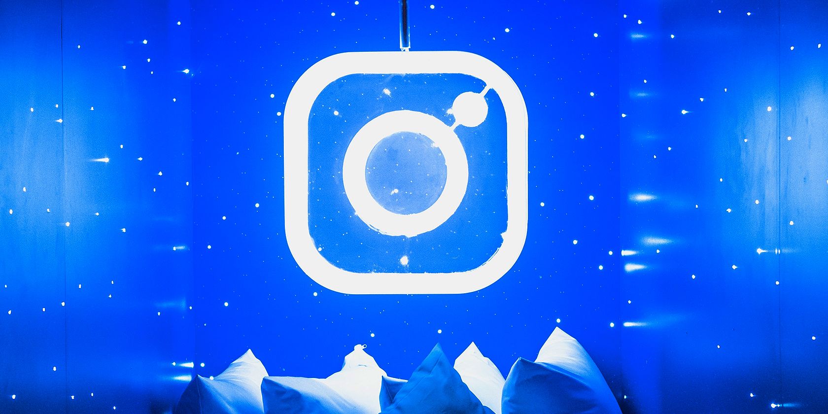 instagram logo in a blue room with white pillows