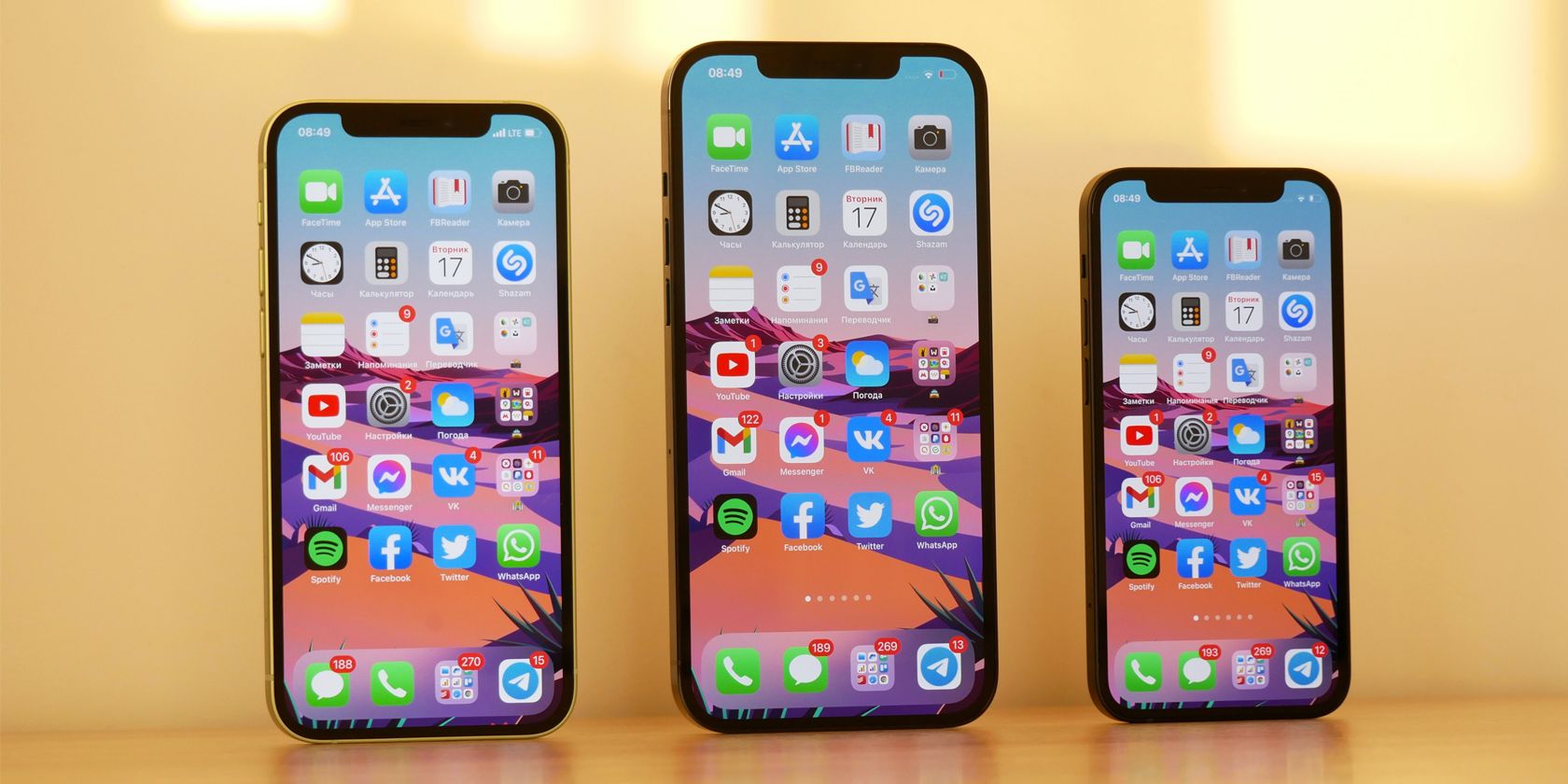 iPhone 12, 12 max and 12 mini in a line, all showing the home screens
