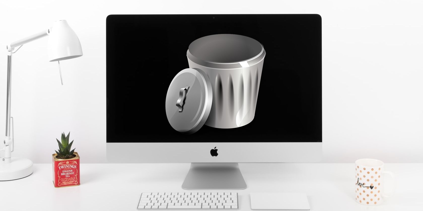 iMac on desk with trash can on screen.