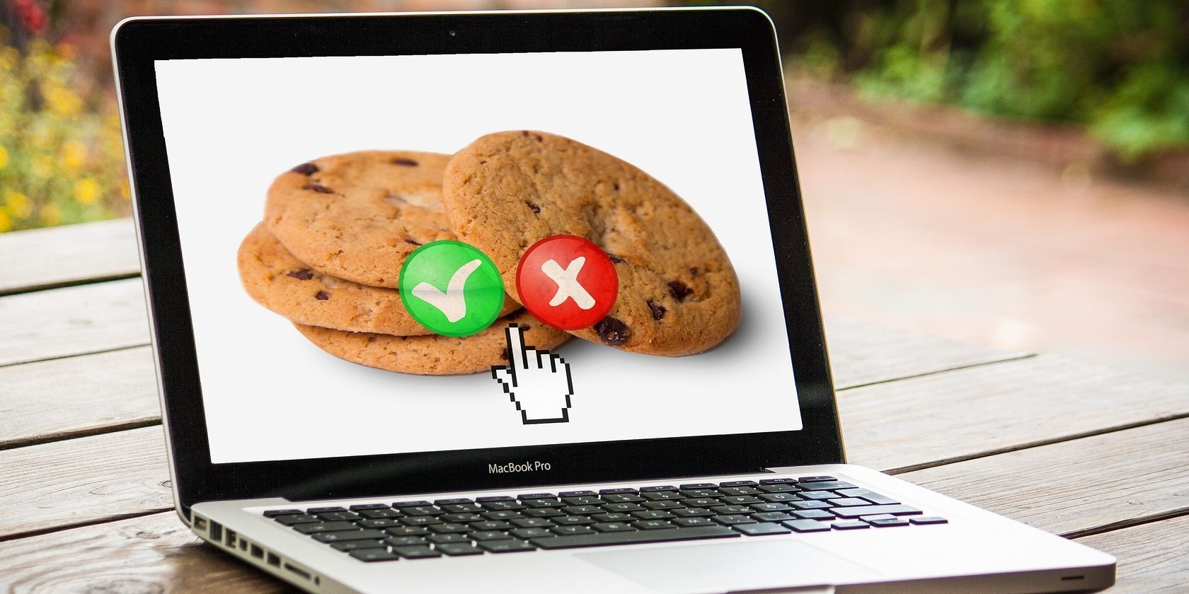 Macbook with cookies and tick and cross options on screen.