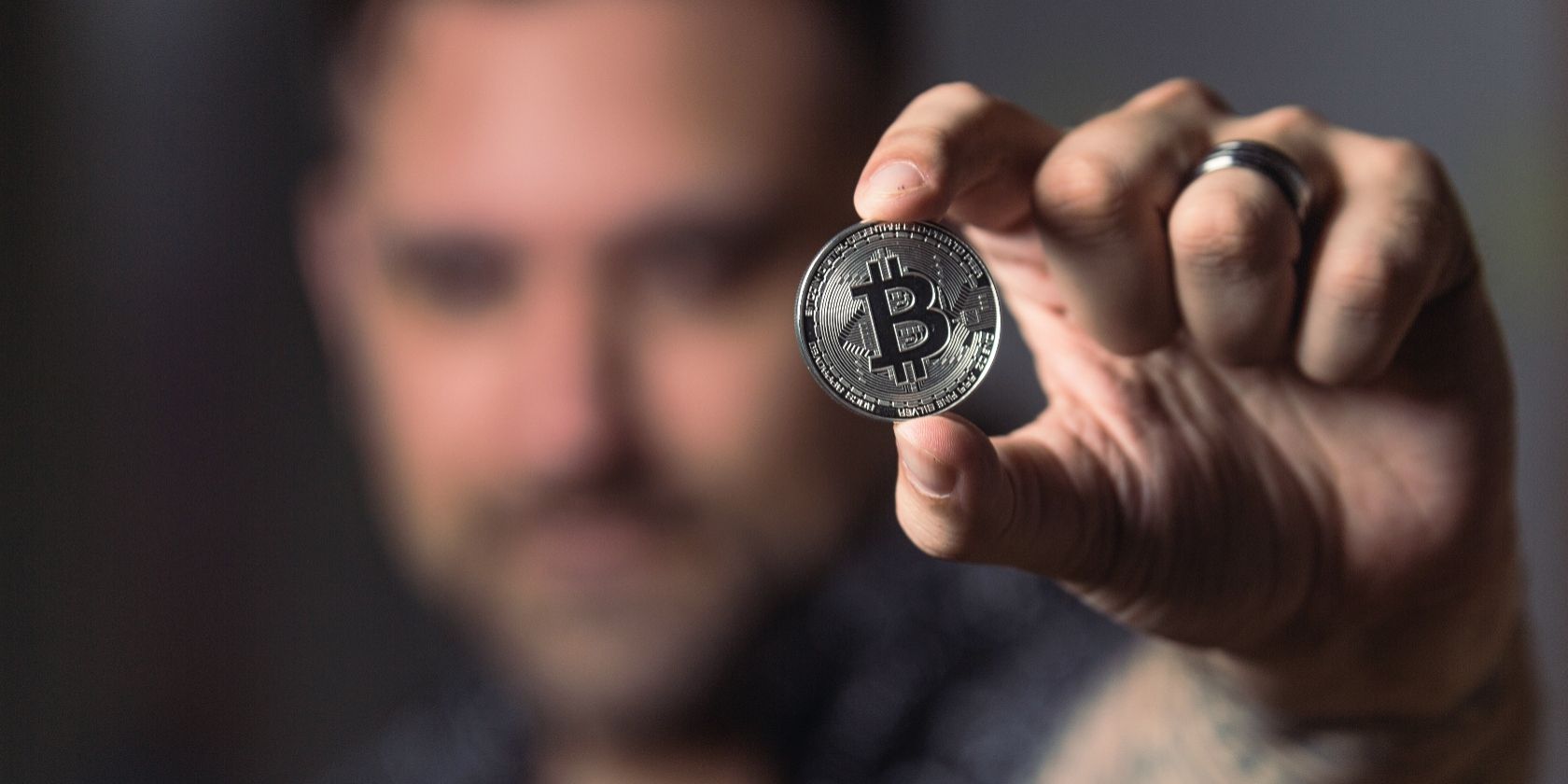 man holding bitcoin in hand