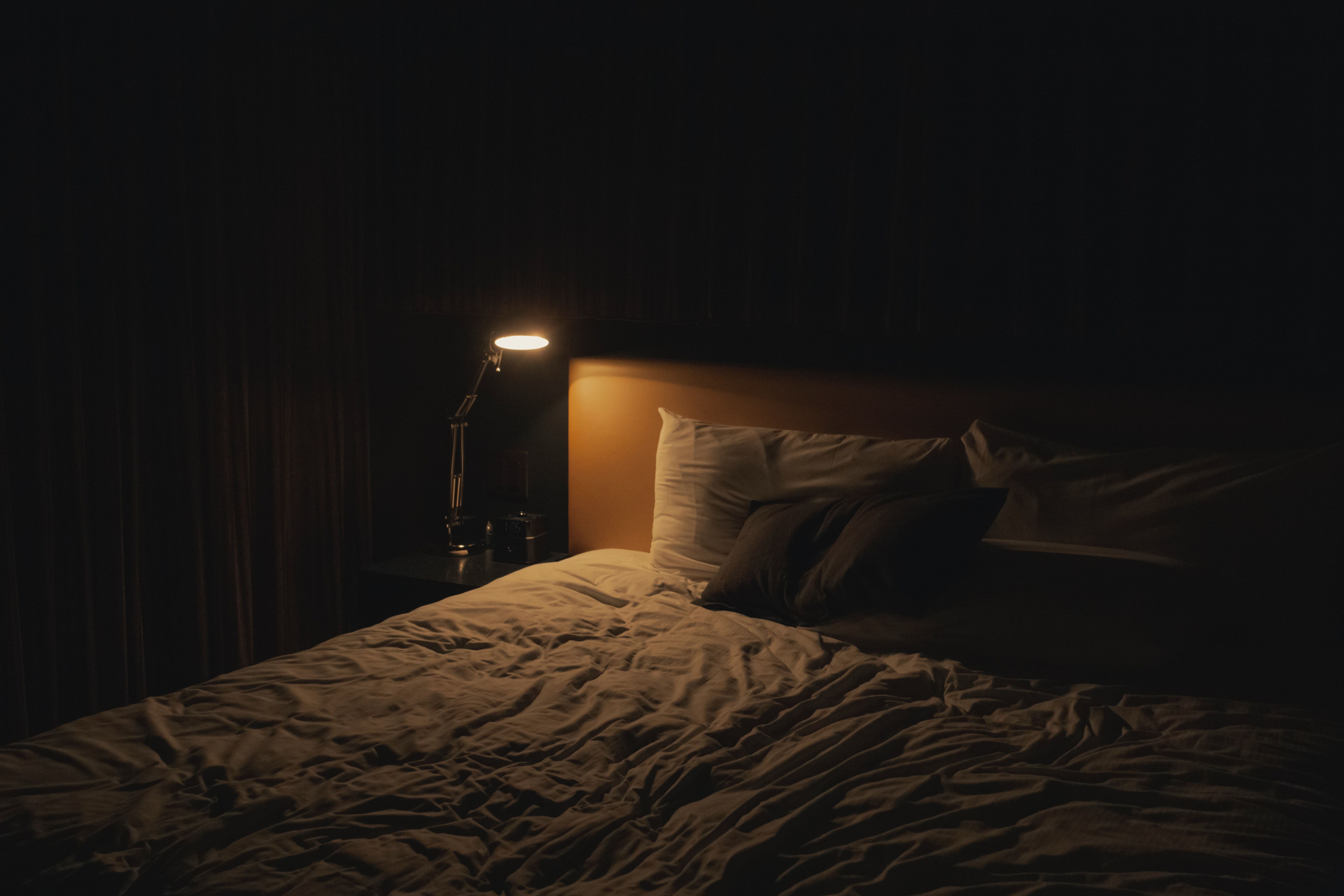 A bed at night.