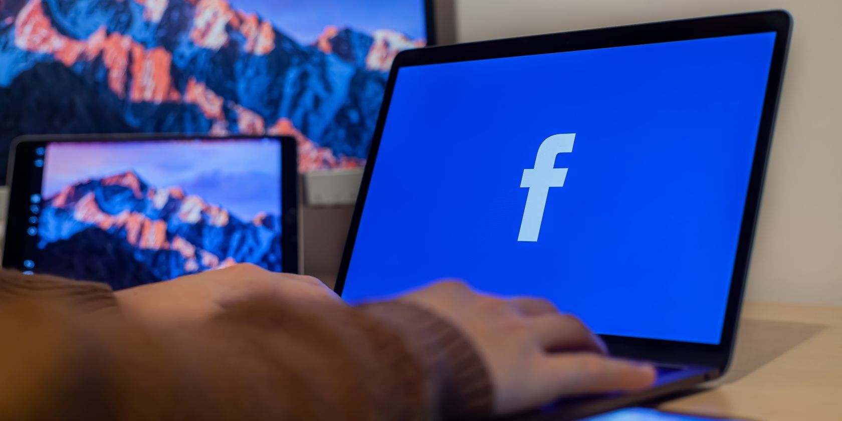 Photo of someone using Facebook on their laptop
