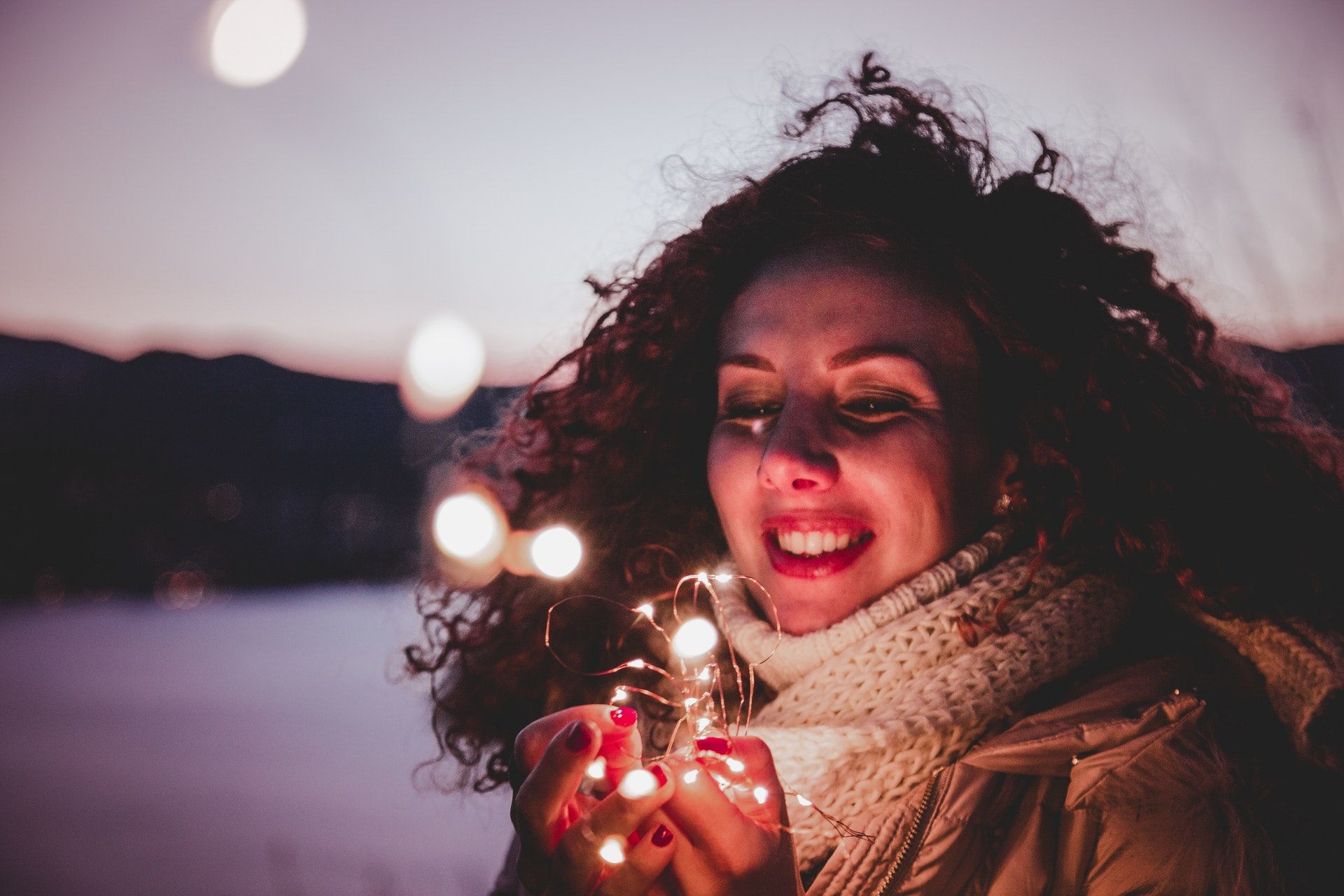 Woman holding holiday decoration lights