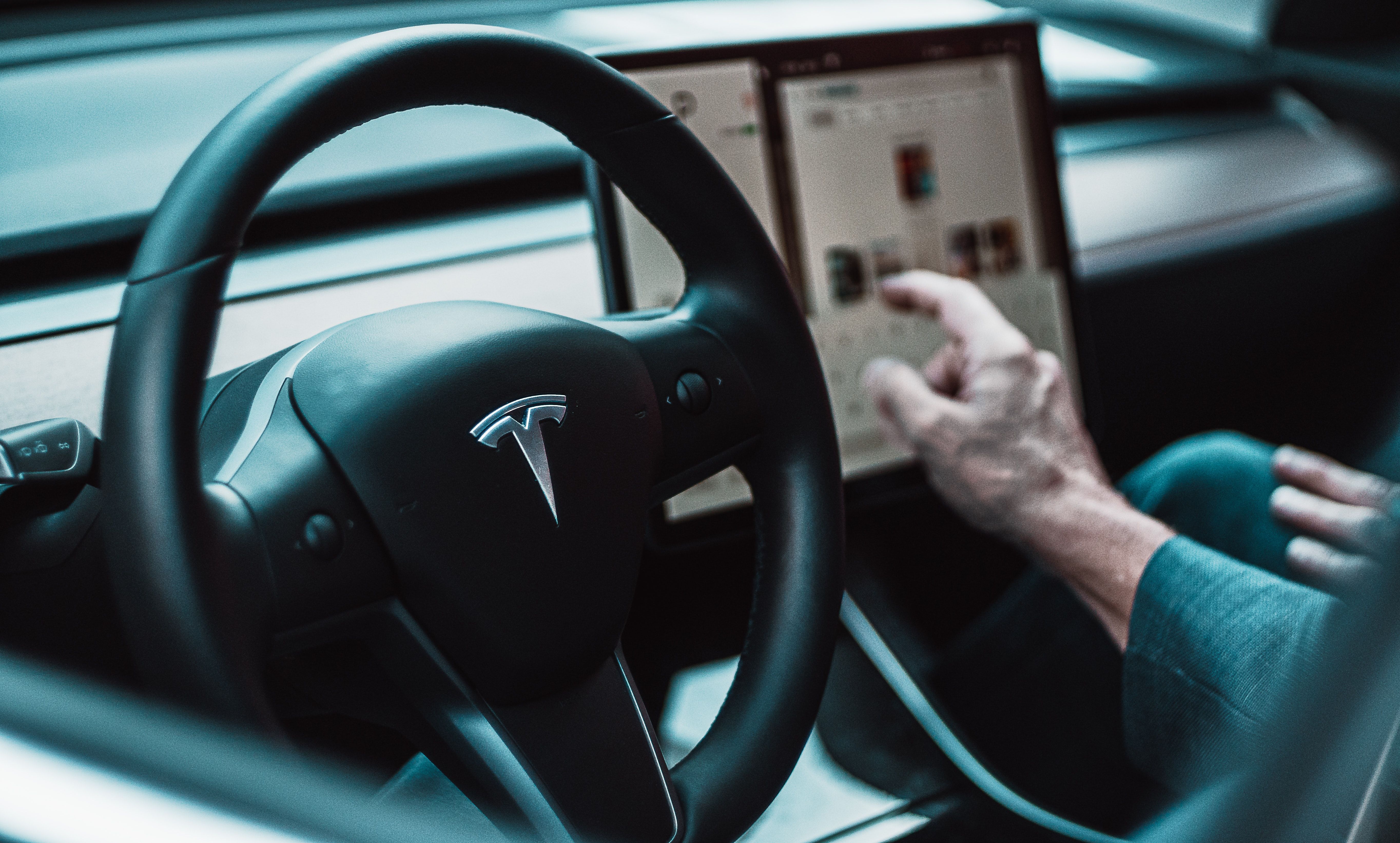 A person operating a Tesla vehicle.
