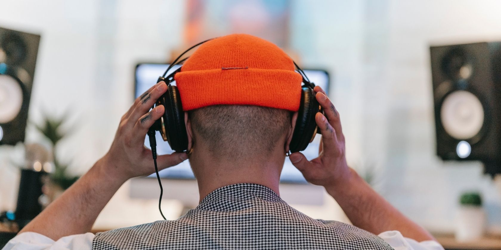 Man with headphones on in front of computer