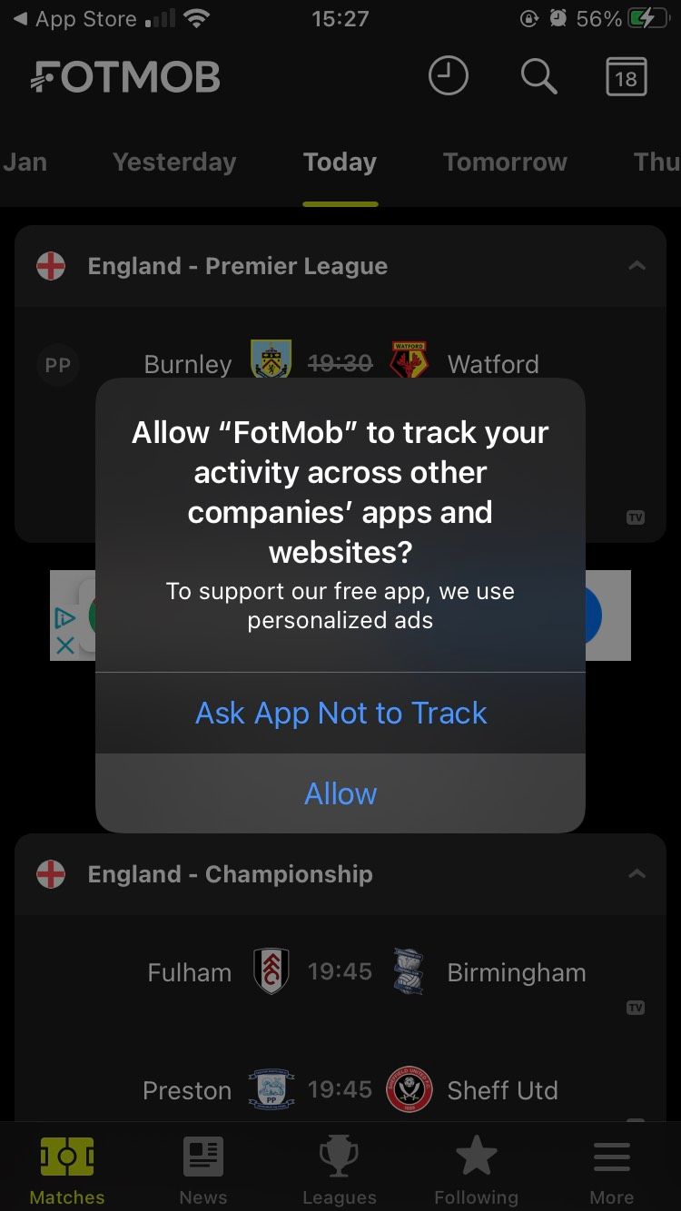 A dialog box requesting user permission to track overlayed atop the FotMob iOS app.