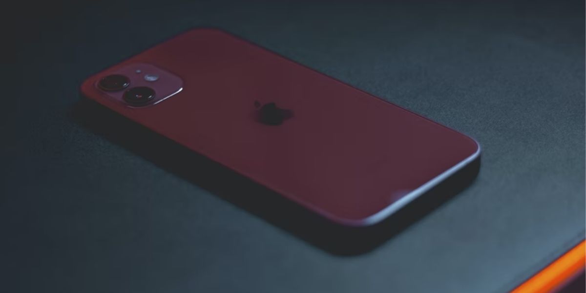 red iphone on black desk