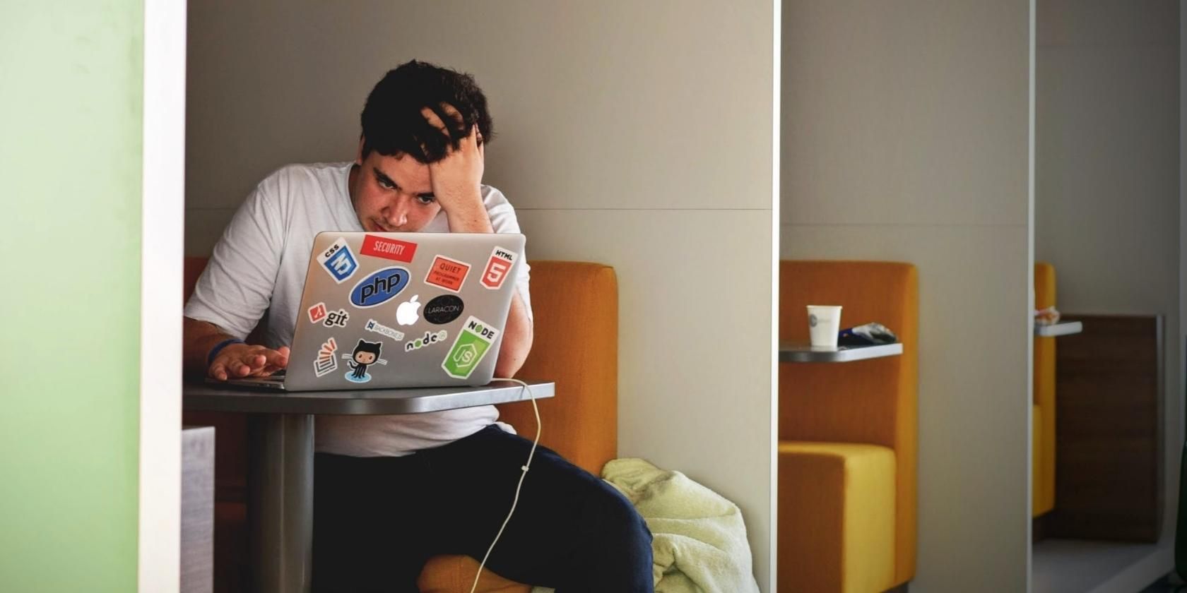 Man Looking Frustrated While Looking on Mac