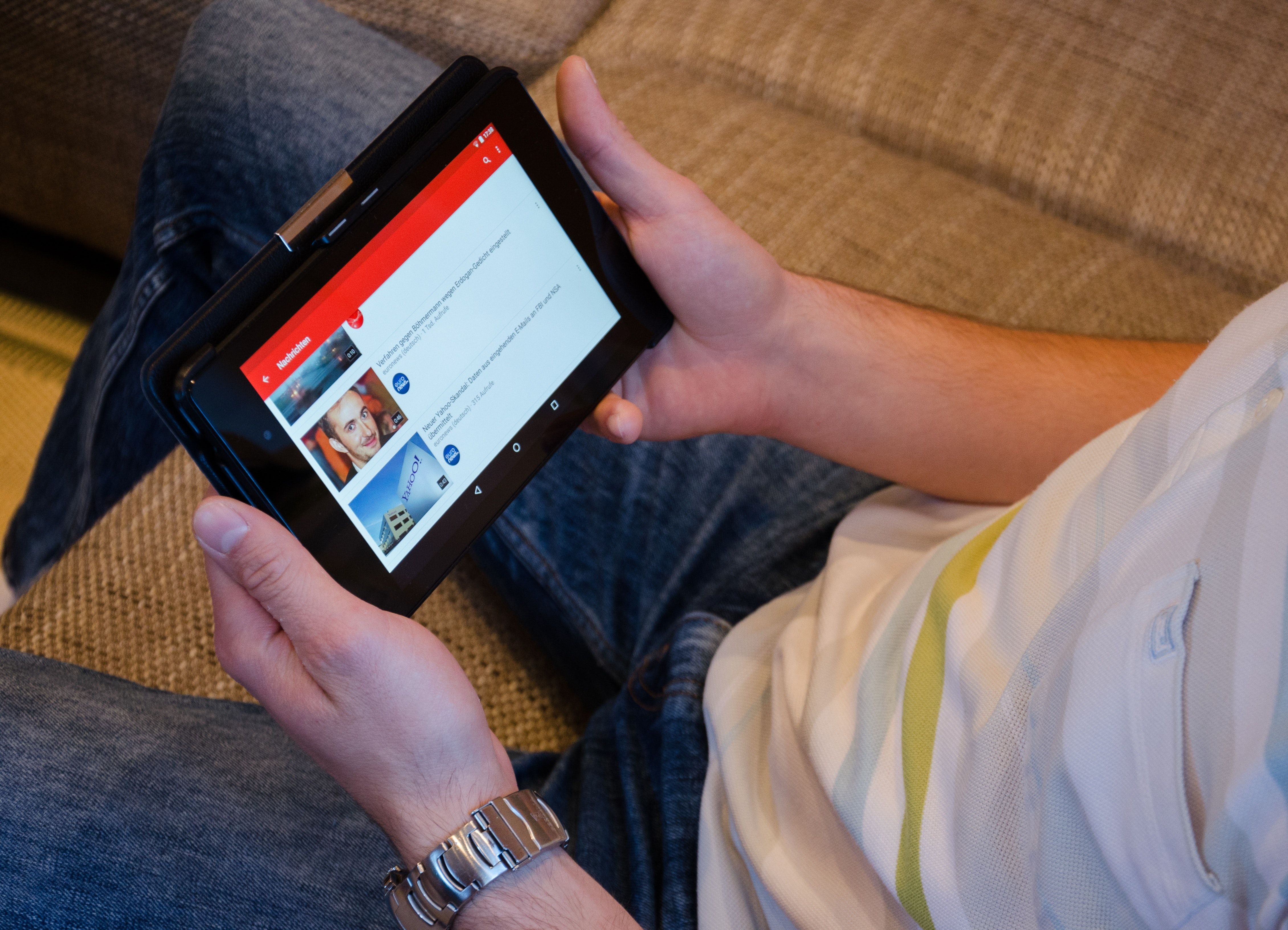 Photo of a person viewing YouTube on their tablet