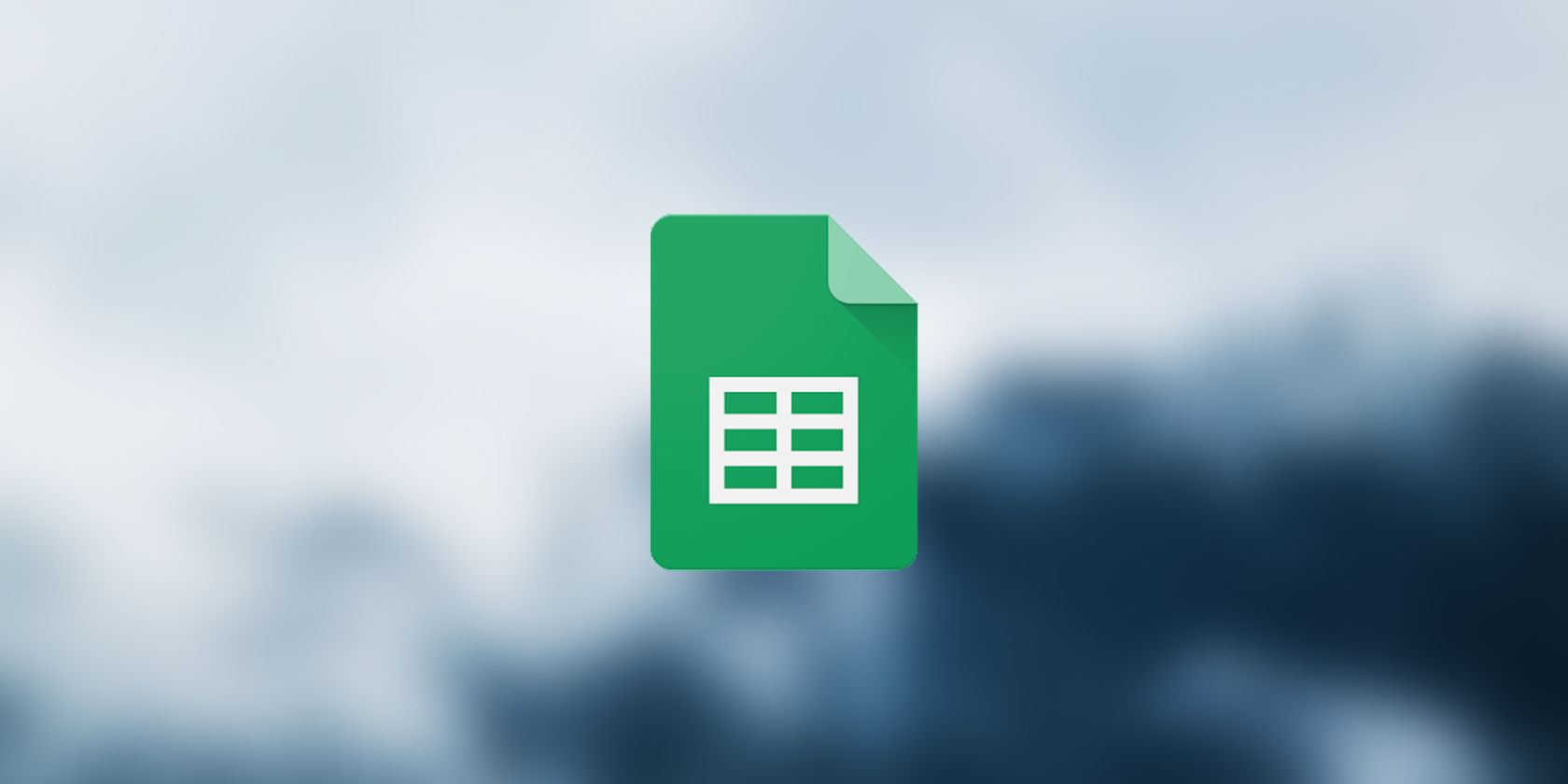 Google Sheets logo on a misty blurred background.