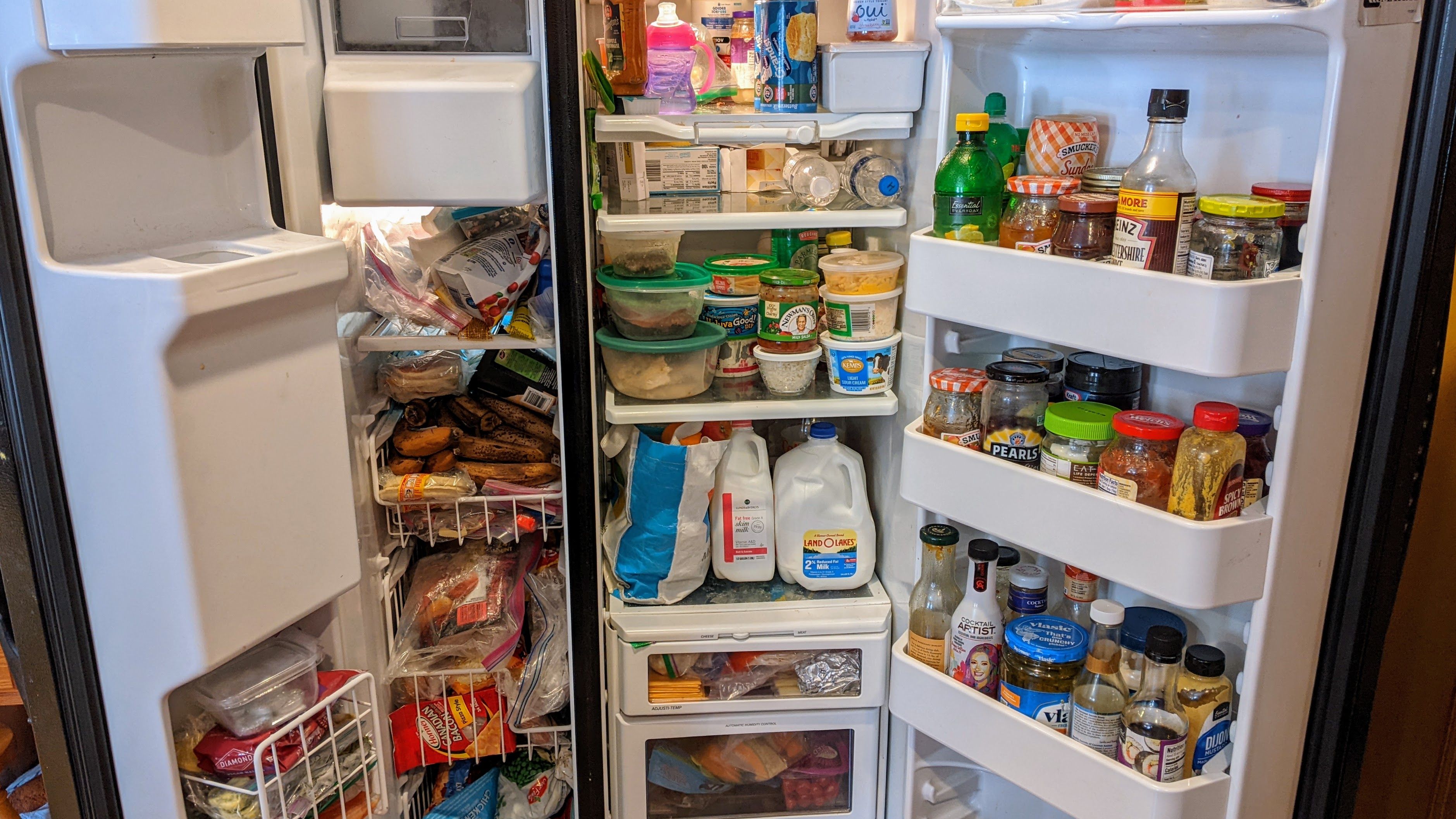 Side-by-side fridge full of food items