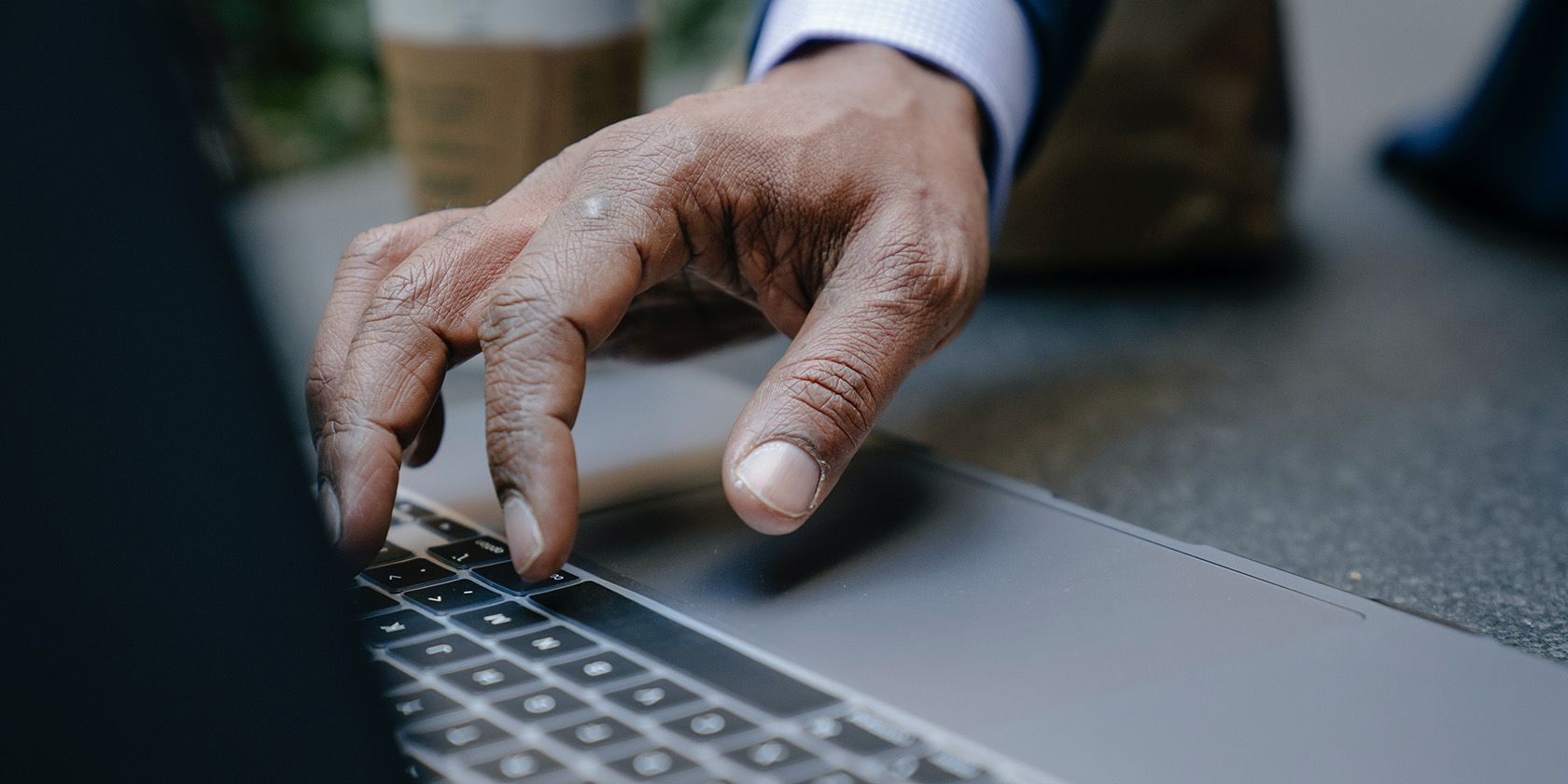 A person typing on MacBook keyboard