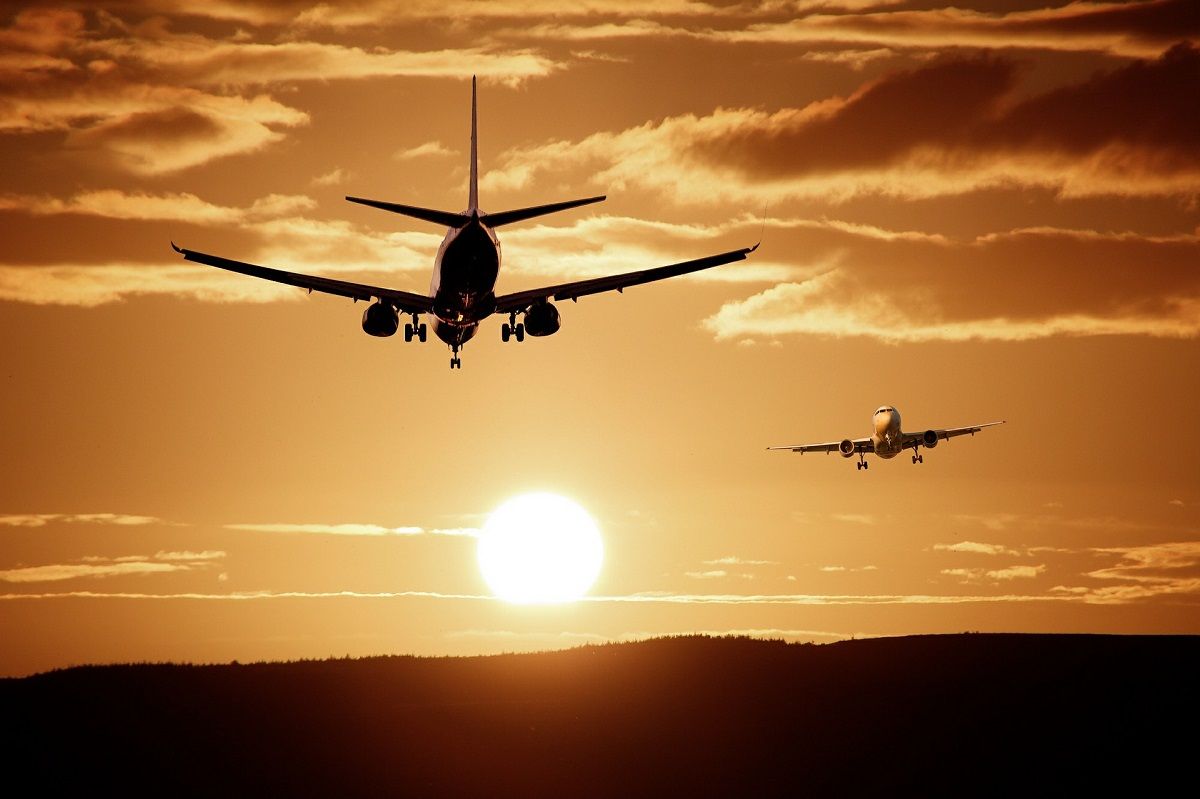 airplanes landing sunset