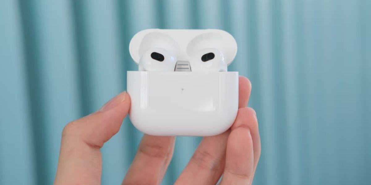 airpods 3 in charging case against light blue background